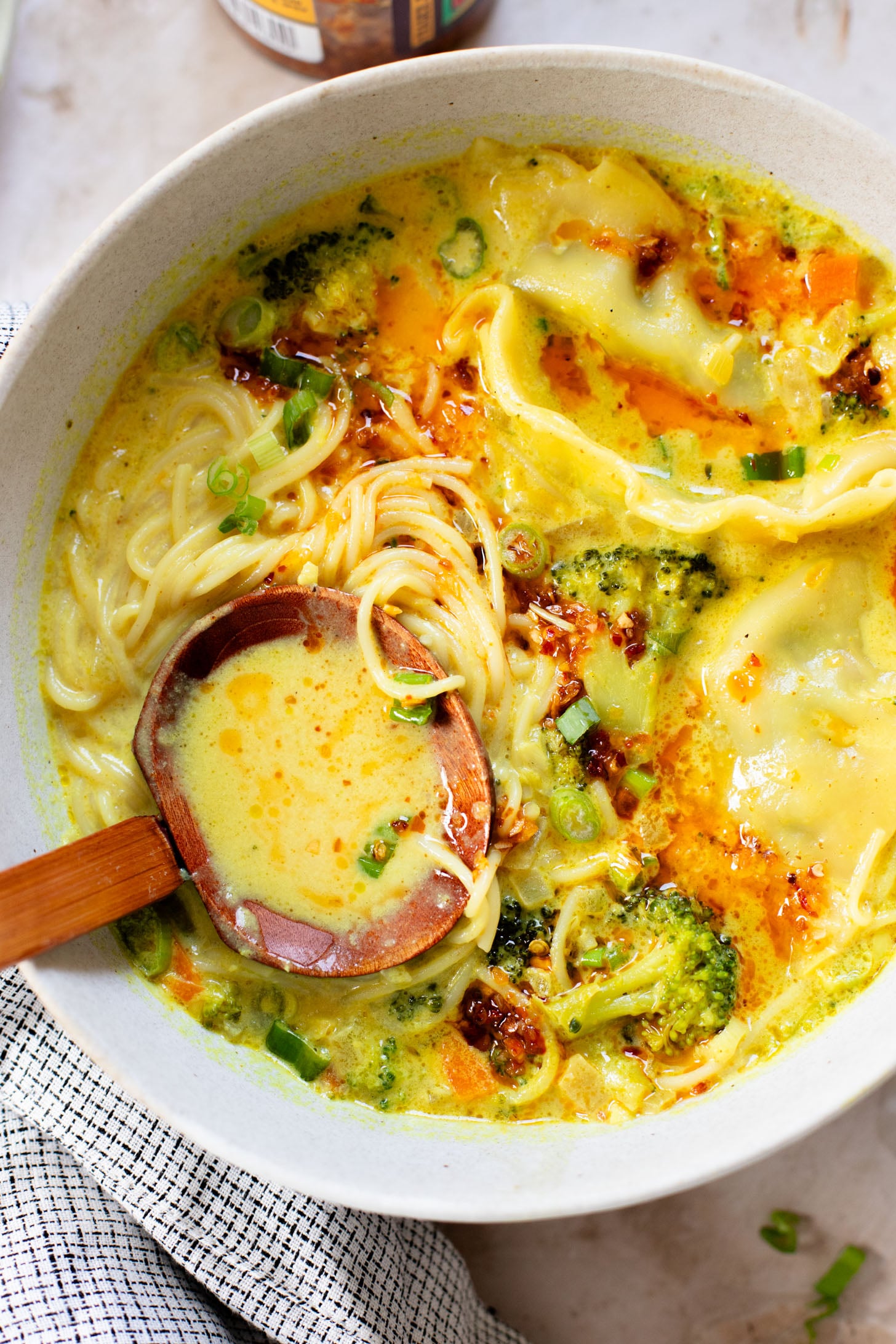 This Curried Coconut Wonton Soup has a dairy-free, creamy broth, plenty of veggies, rice noodles and vegan wontons | ThisSavoryVegan.com