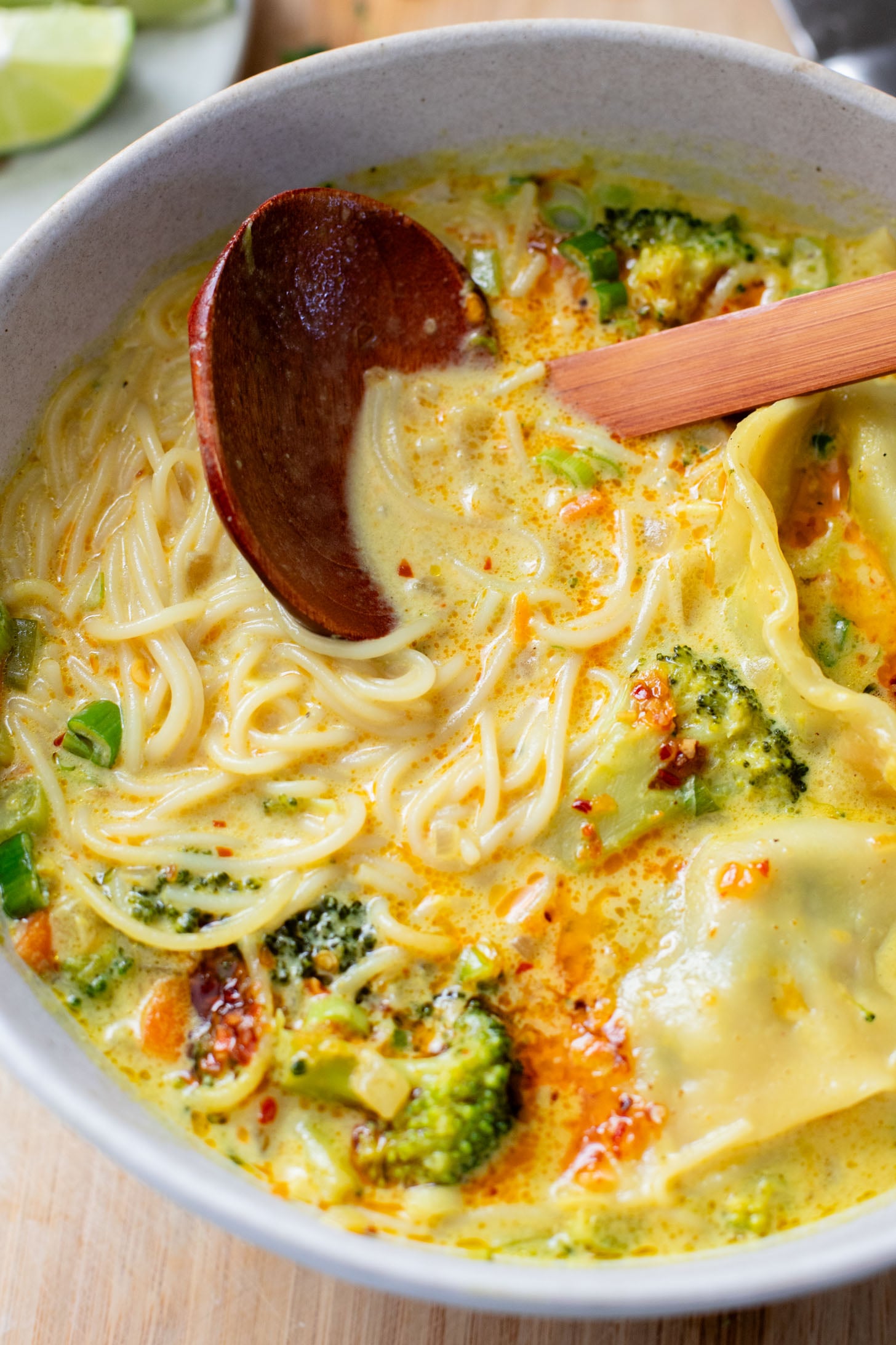This Curried Coconut Wonton Soup has a dairy-free, creamy broth, plenty of veggies, rice noodles and vegan wontons | ThisSavoryVegan.com