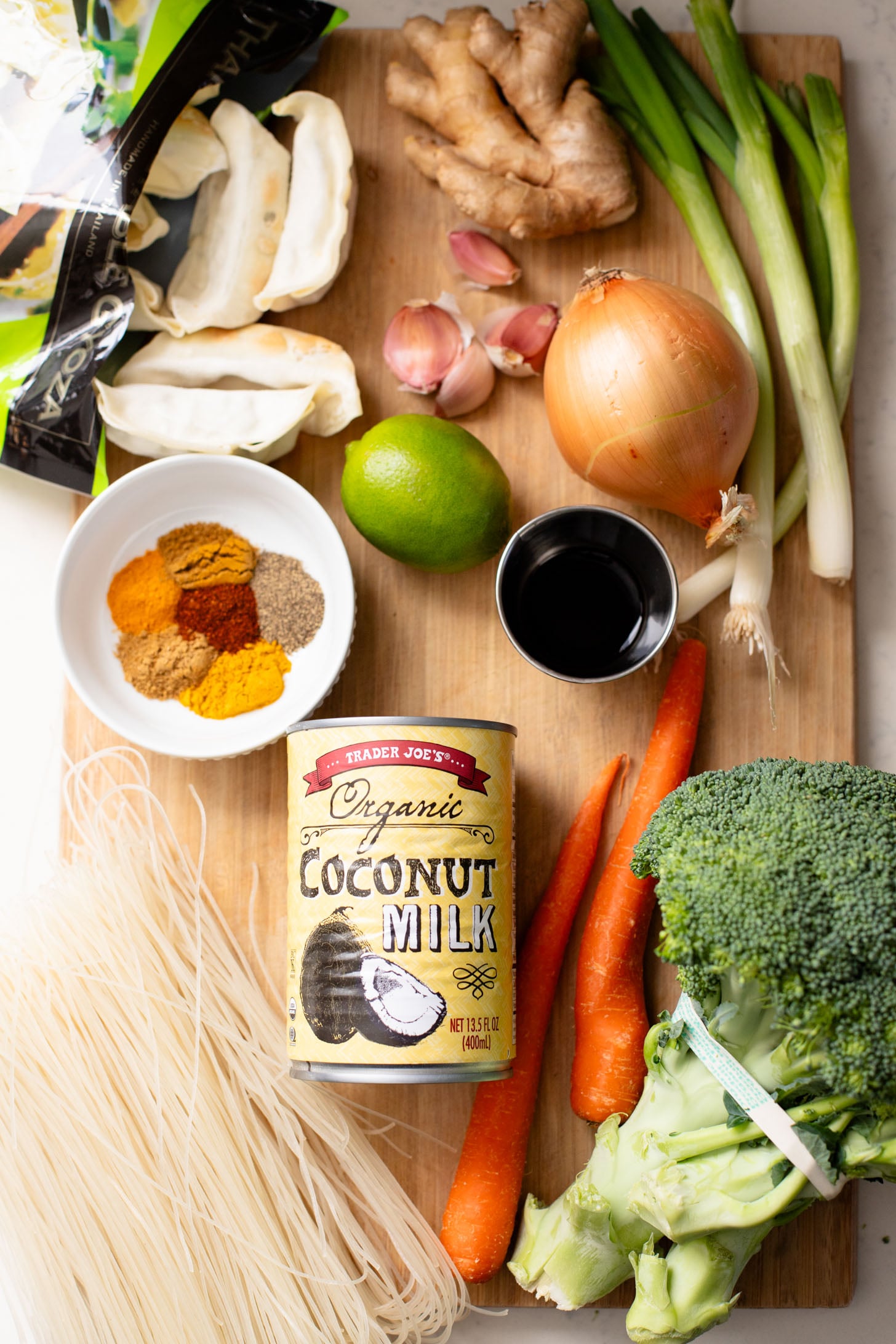 This Curried Coconut Wonton Soup has a dairy-free, creamy broth, plenty of veggies, rice noodles and vegan wontons | ThisSavoryVegan.com