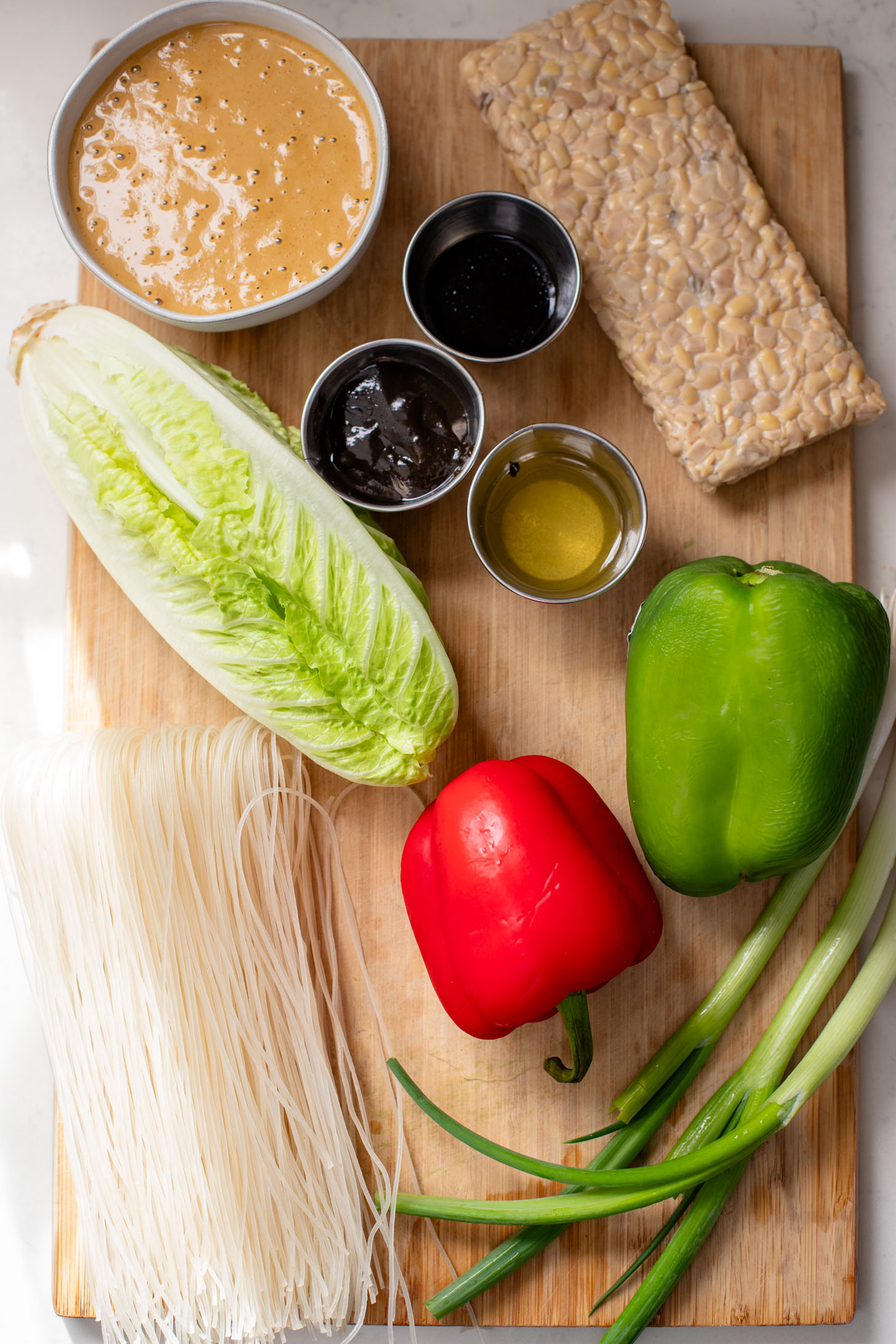 These Hoisin Tempeh Peanut Noodle Bowls are the perfect quick dinner! Crispy tempeh, rice noodles, veggies and the BEST peanut sauce | ThisSavoryVegan.com