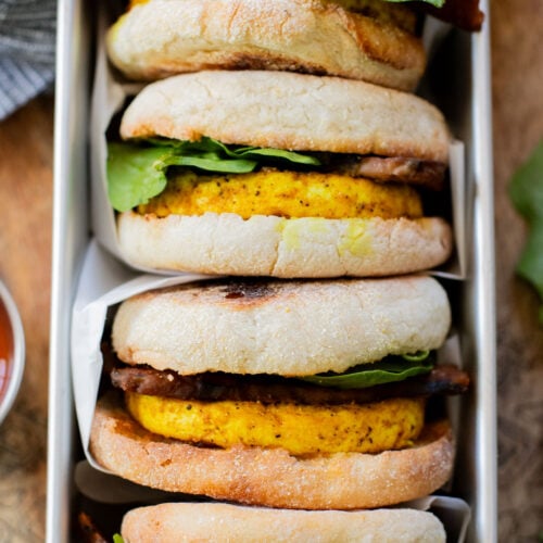 These Tofu Breakfast Sandwiches are the perfect breakfast on the go. Layered with seasoned tofu, tempeh bacon and spinach | ThisSavoryVegan.com