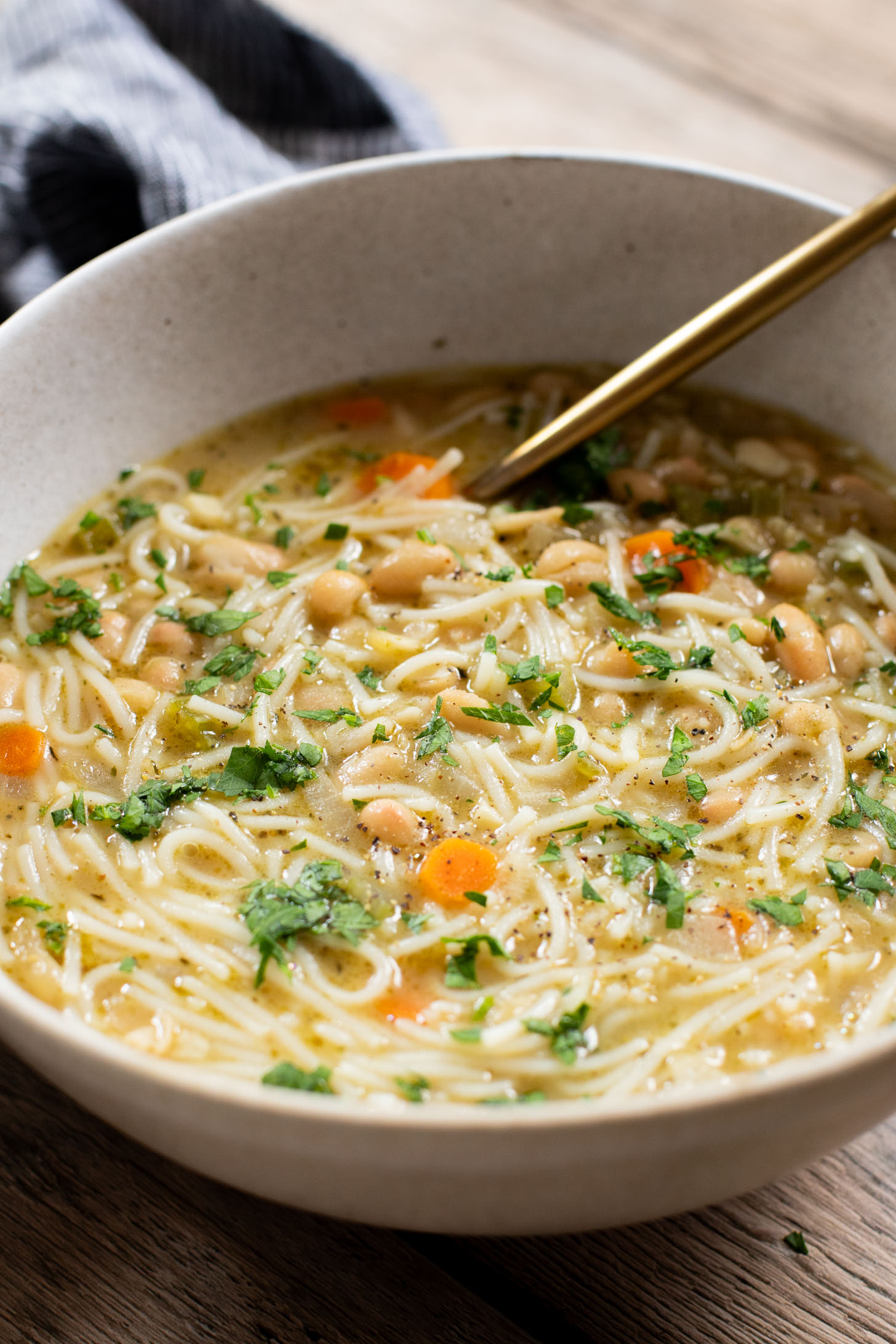 This White Bean Noodle Soup is the perfect swap for chicken noodle soup! It is 100% vegan and great when you want something cozy & comforting | ThisSavoryVegan.com