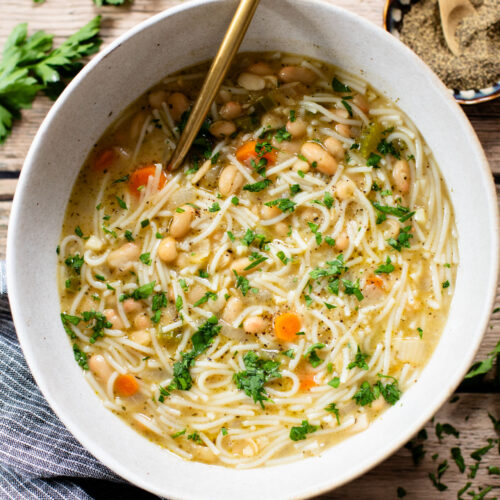 This White Bean Noodle Soup is the perfect swap for chicken noodle soup! It is 100% vegan and great when you want something cozy & comforting | ThisSavoryVegan.com