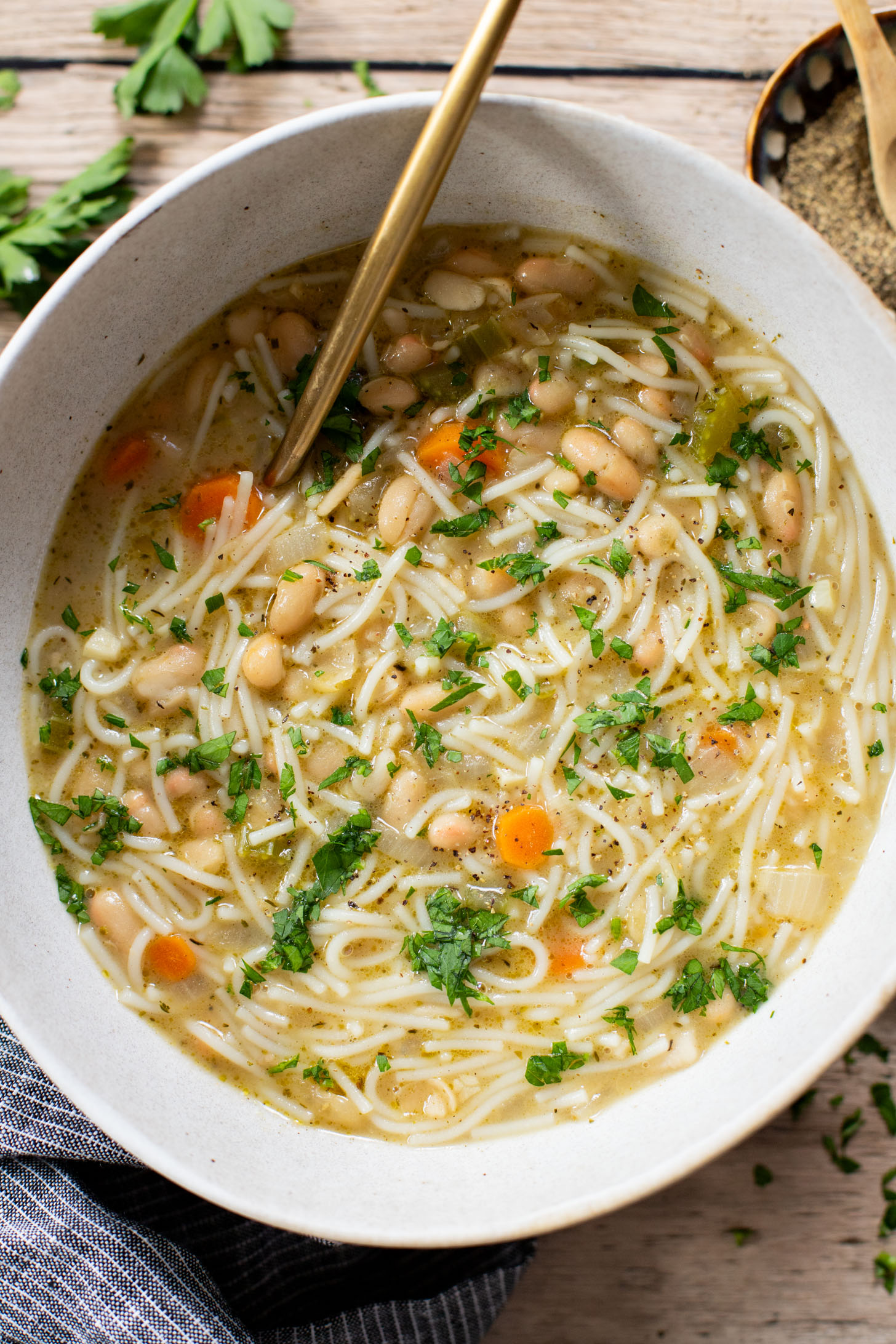 This White Bean Noodle Soup is the perfect swap for chicken noodle soup! It is 100% vegan and great when you want something cozy & comforting | ThisSavoryVegan.com