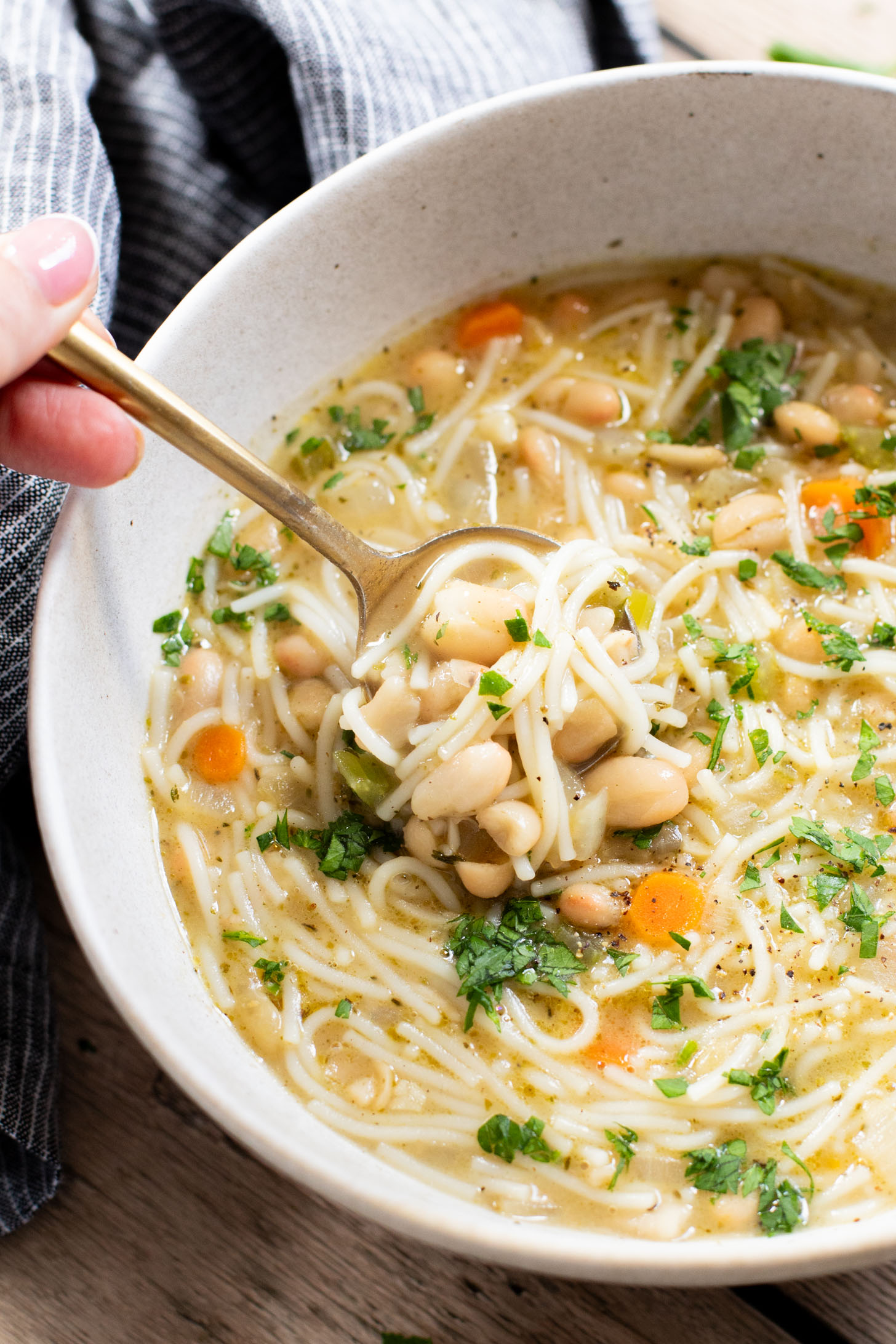 This White Bean Noodle Soup is the perfect swap for chicken noodle soup! It is 100% vegan and great when you want something cozy & comforting | ThisSavoryVegan.com