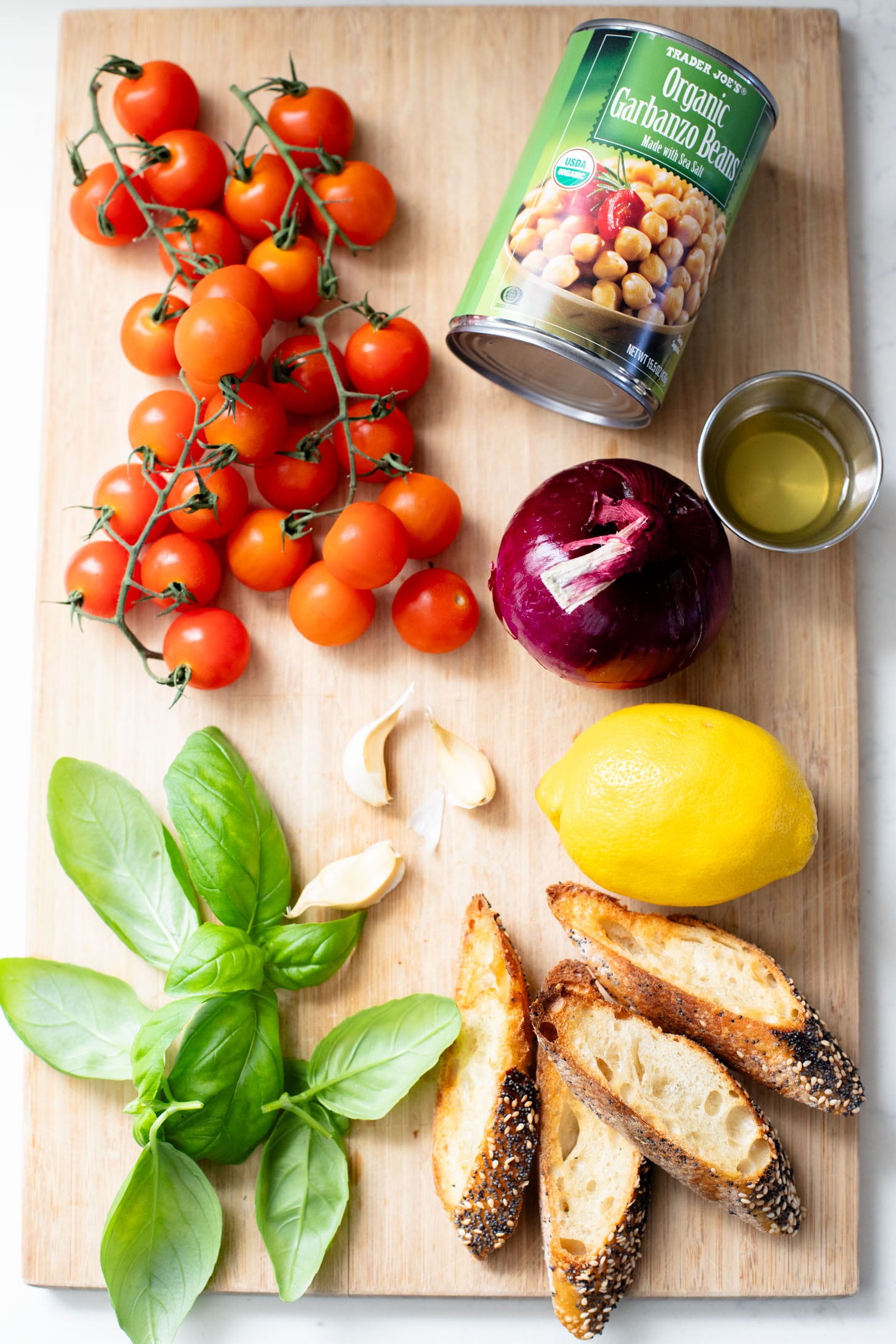 This Tomato & Chickpea Salad is a bright & fresh salad recipe that is perfect for a quick lunch! Best served with toasted bread | ThisSavoryVegan.com