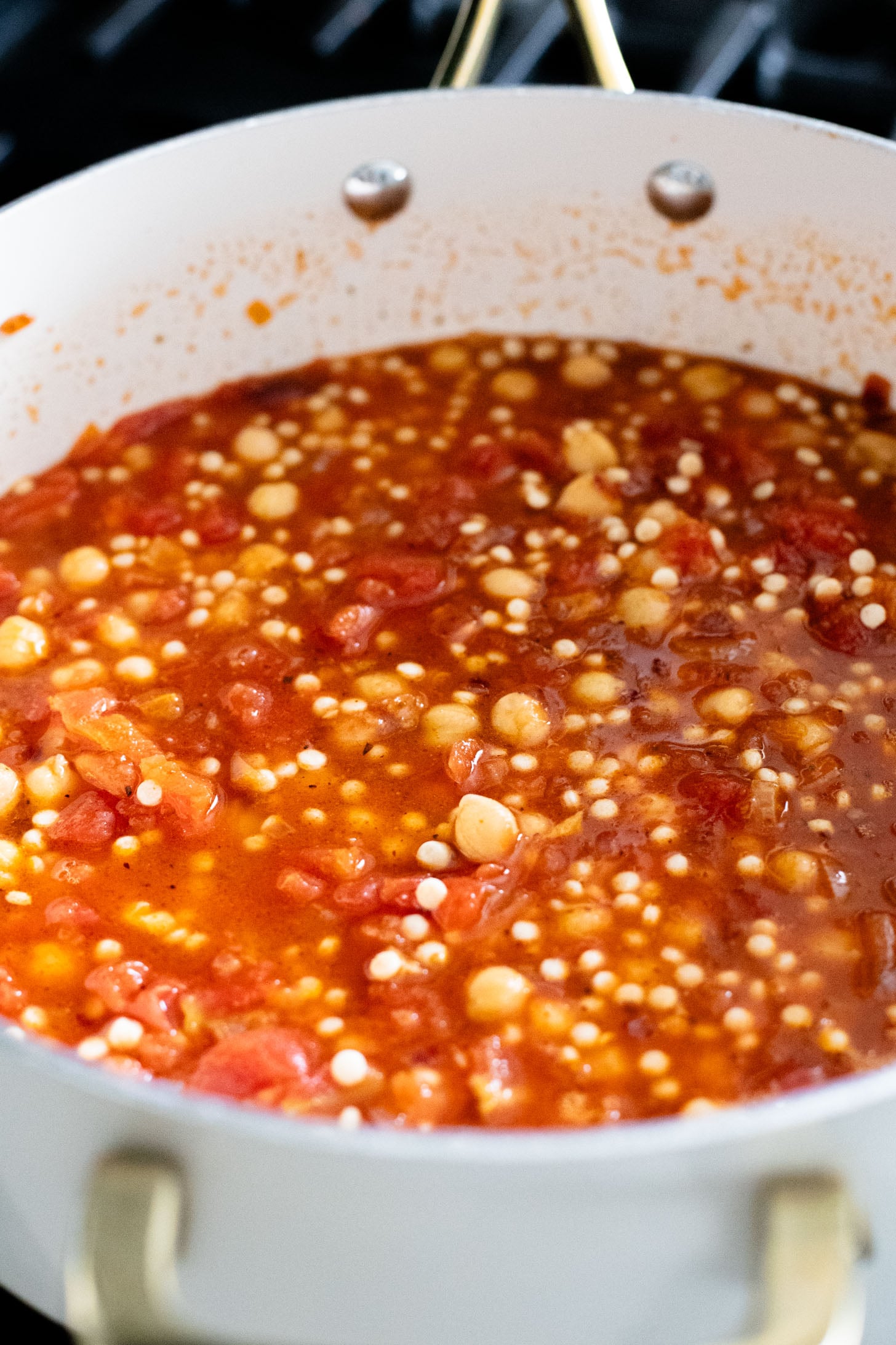 This Chickpea Couscous Skillet is a quick and healthy vegan dinner with a delicious tomato sauce, rainbow chard, pearl couscous & chickpeas | ThisSavoryVegan.com