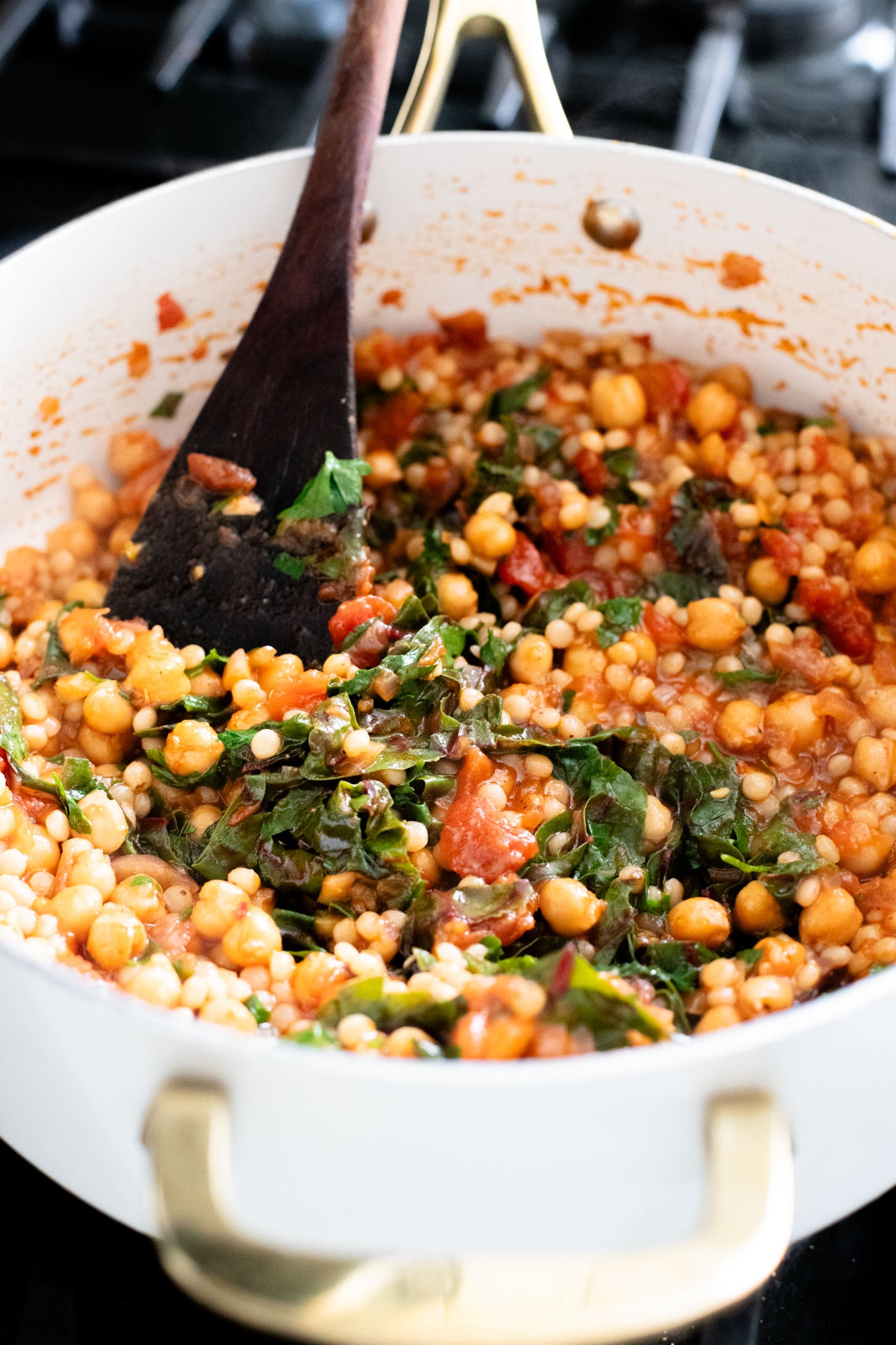 This Chickpea Couscous Skillet is a quick and healthy vegan dinner with a delicious tomato sauce, rainbow chard, pearl couscous & chickpeas | ThisSavoryVegan.com