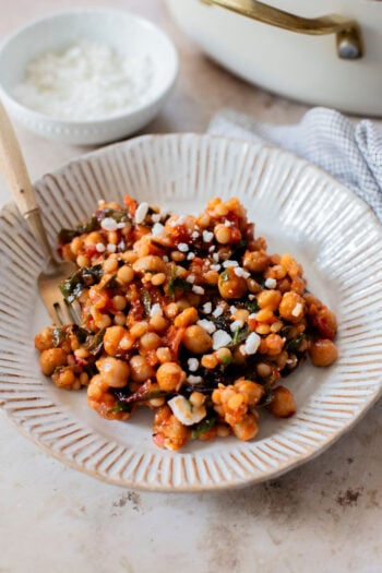 This Chickpea Couscous Skillet is a quick and healthy vegan dinner with a delicious tomato sauce, rainbow chard, pearl couscous & chickpeas | ThisSavoryVegan.com
