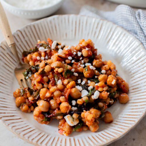 This Chickpea Couscous Skillet is a quick and healthy vegan dinner with a delicious tomato sauce, rainbow chard, pearl couscous & chickpeas | ThisSavoryVegan.com