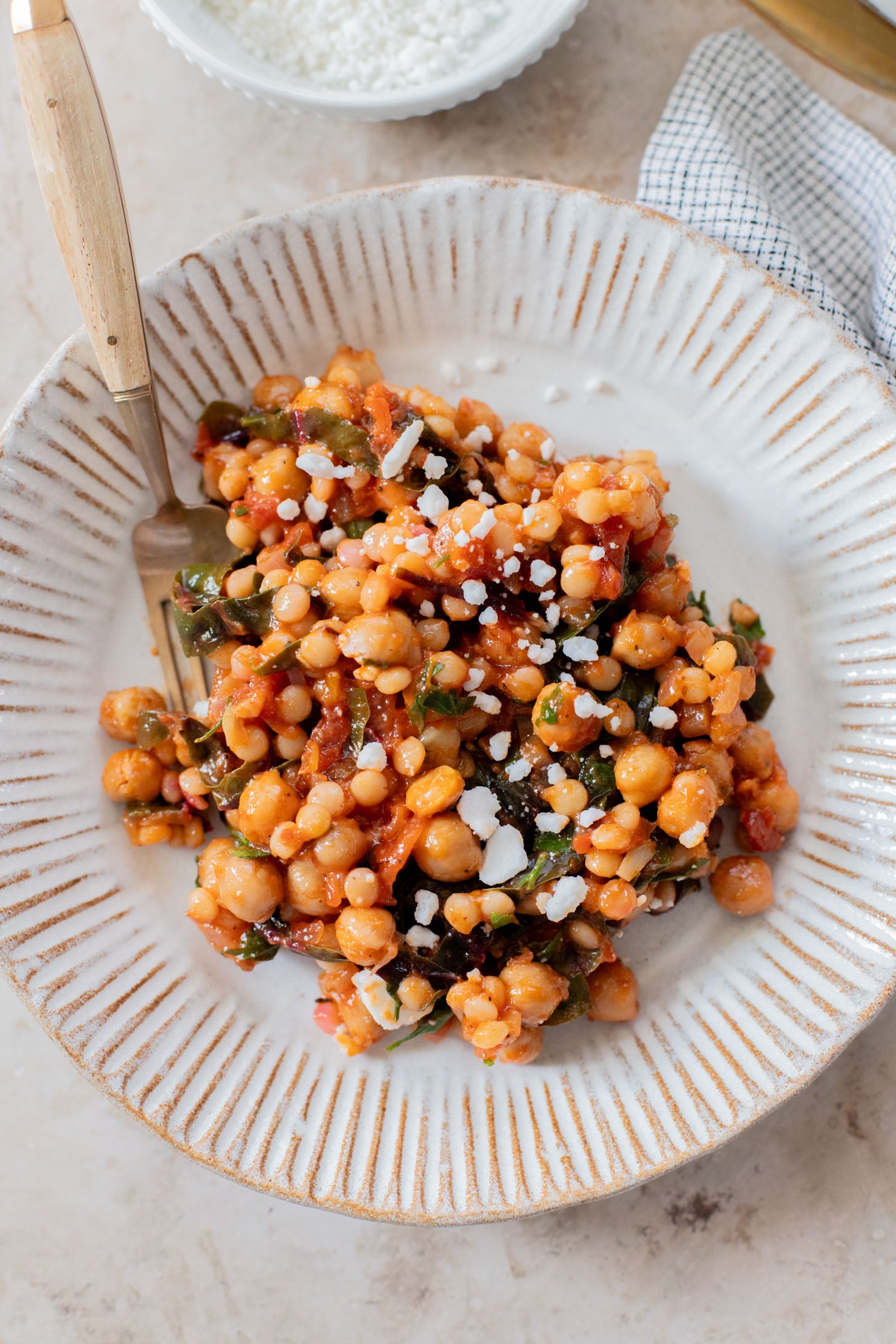 This Chickpea Couscous Skillet is a quick and healthy vegan dinner with a delicious tomato sauce, rainbow chard, pearl couscous & chickpeas | ThisSavoryVegan.com