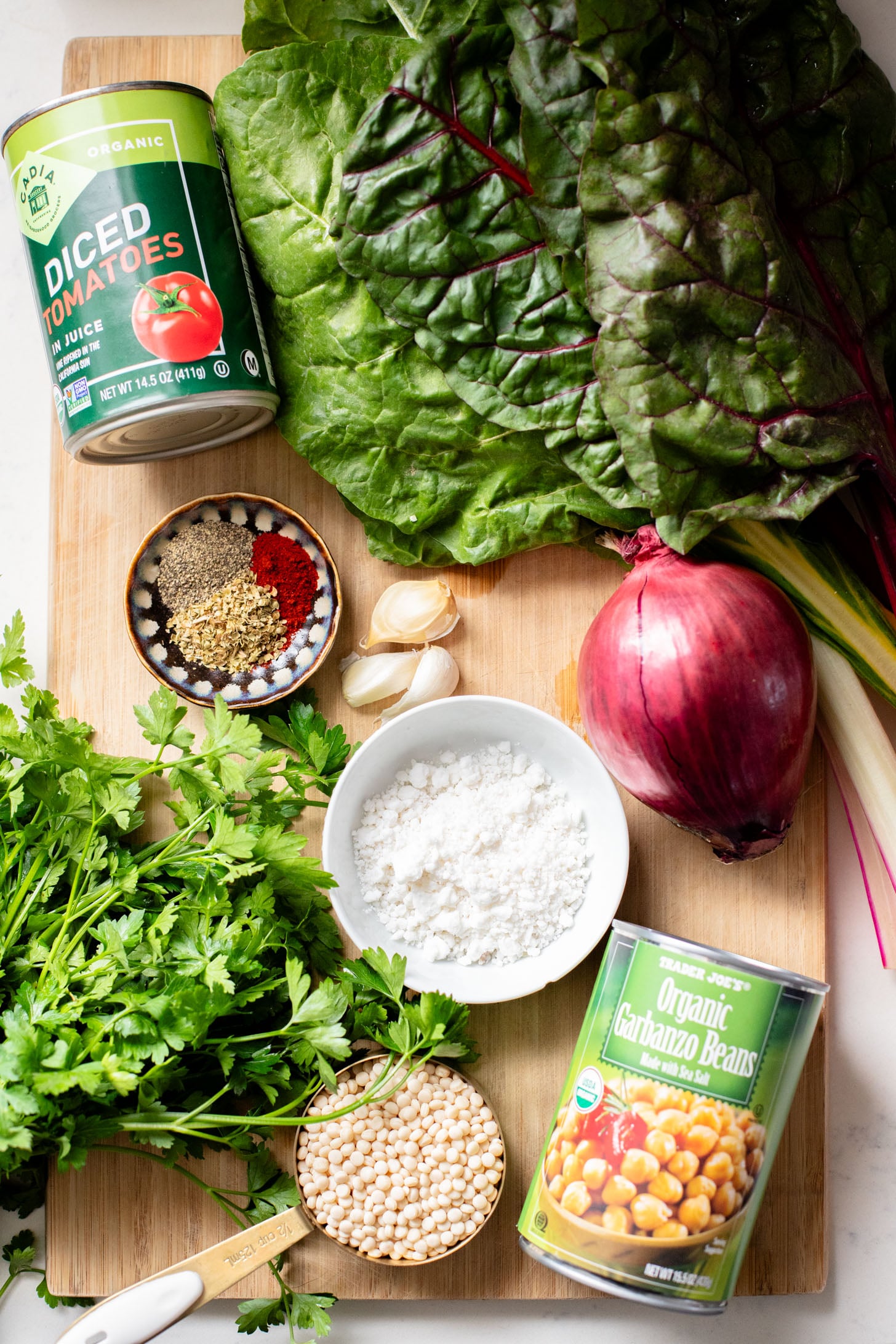 This Chickpea Couscous Skillet is a quick and healthy vegan dinner with a delicious tomato sauce, rainbow chard, pearl couscous & chickpeas | ThisSavoryVegan.com