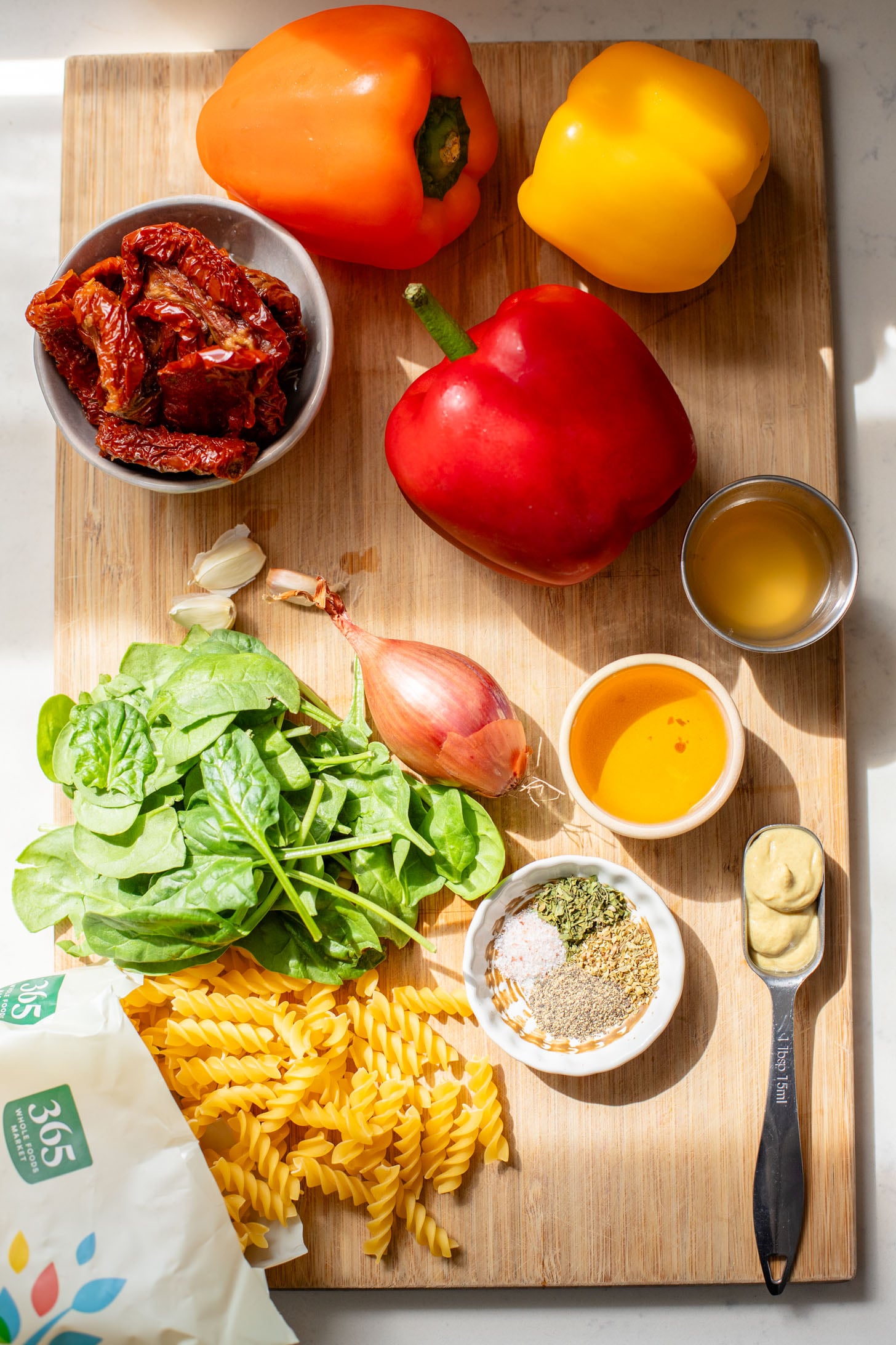 This Roasted Pepper Pasta Salad is simple but packed with flavor. Loaded with pasta, sun-dried tomatoes, roasted peppers and a light dressing | ThisSavoryVegan.com