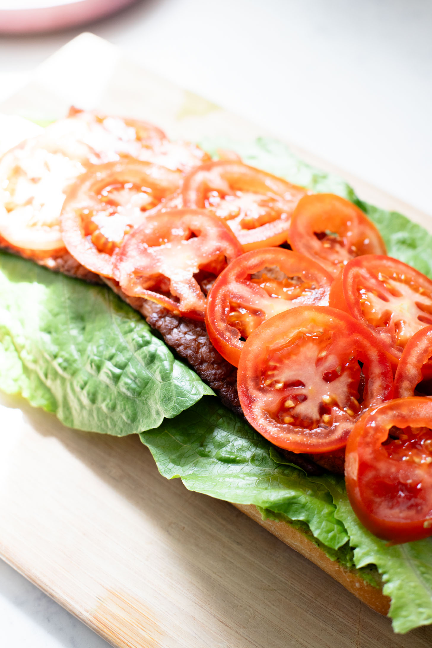 This Vegan Pesto BLT is a dream of a sandwich. Made with homemade pesto, crispy tempeh bacon on toasted ciabatta. You can't go wrong | ThisSavoryVegan.com
