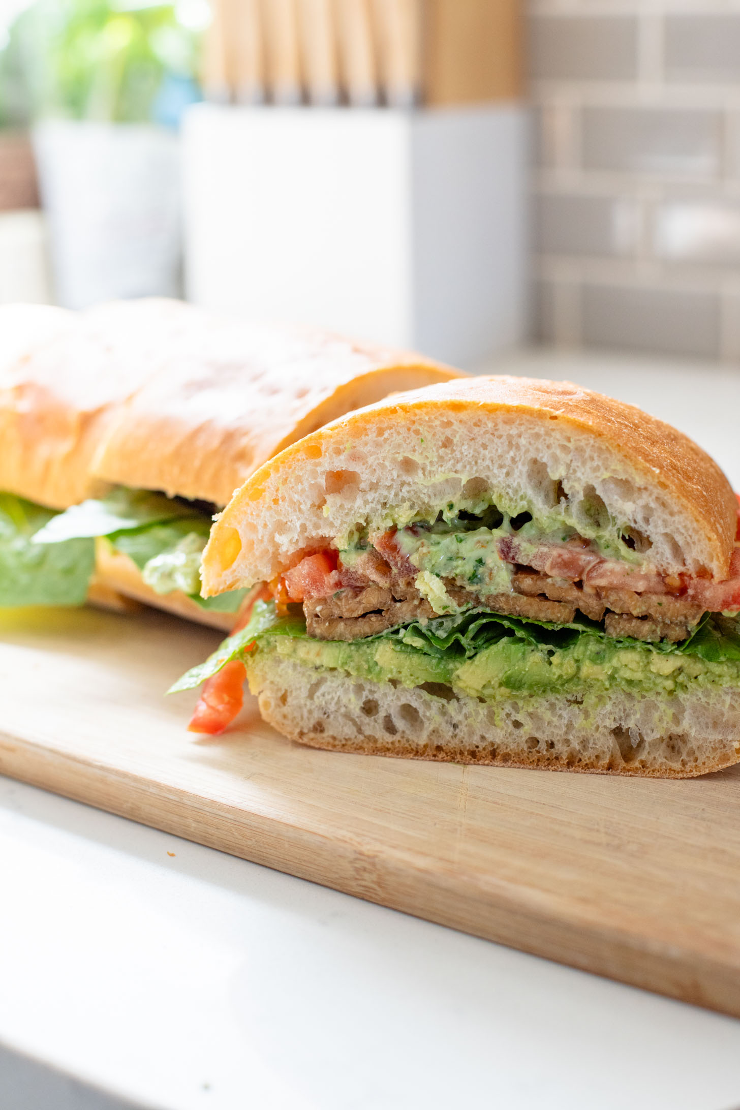 This Vegan Pesto BLT is a dream of a sandwich. Made with homemade pesto, crispy tempeh bacon on toasted ciabatta. You can't go wrong | ThisSavoryVegan.com