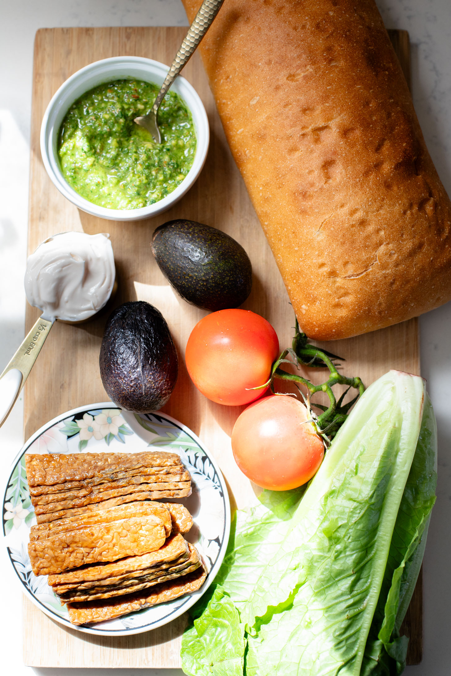 This Vegan Pesto BLT is a dream of a sandwich. Made with homemade pesto, crispy tempeh bacon on toasted ciabatta. You can't go wrong | ThisSavoryVegan.com