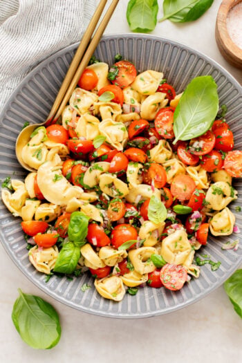 This Tomato Basil Tortellini Salad is made with chilled vegan tortellini, cherry tomatoes, balsamic, garlic & fresh herbs. The perfect summer salad | ThisSavoryVegan.com