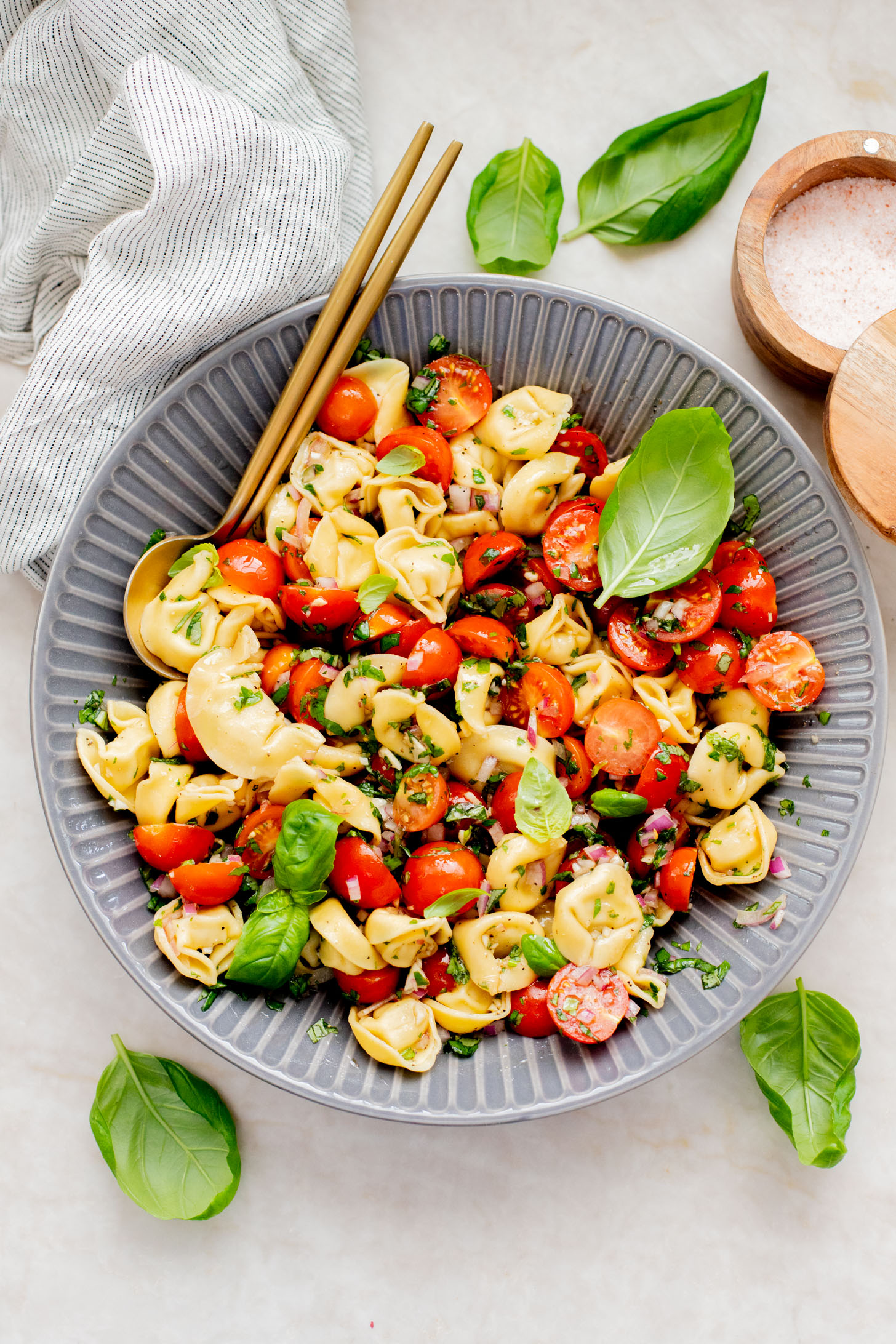 This Tomato Basil Tortellini Salad is made with chilled vegan tortellini, cherry tomatoes, balsamic, garlic & fresh herbs. The perfect summer salad | ThisSavoryVegan.com
