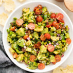This Avocado Tomato Salad is a hearty side dish or appetizer. Best served with tortilla chips for the perfect bite | ThisSavoryVegan.com