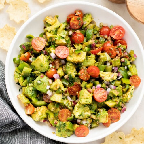 This Avocado Tomato Salad is a hearty side dish or appetizer. Best served with tortilla chips for the perfect bite | ThisSavoryVegan.com