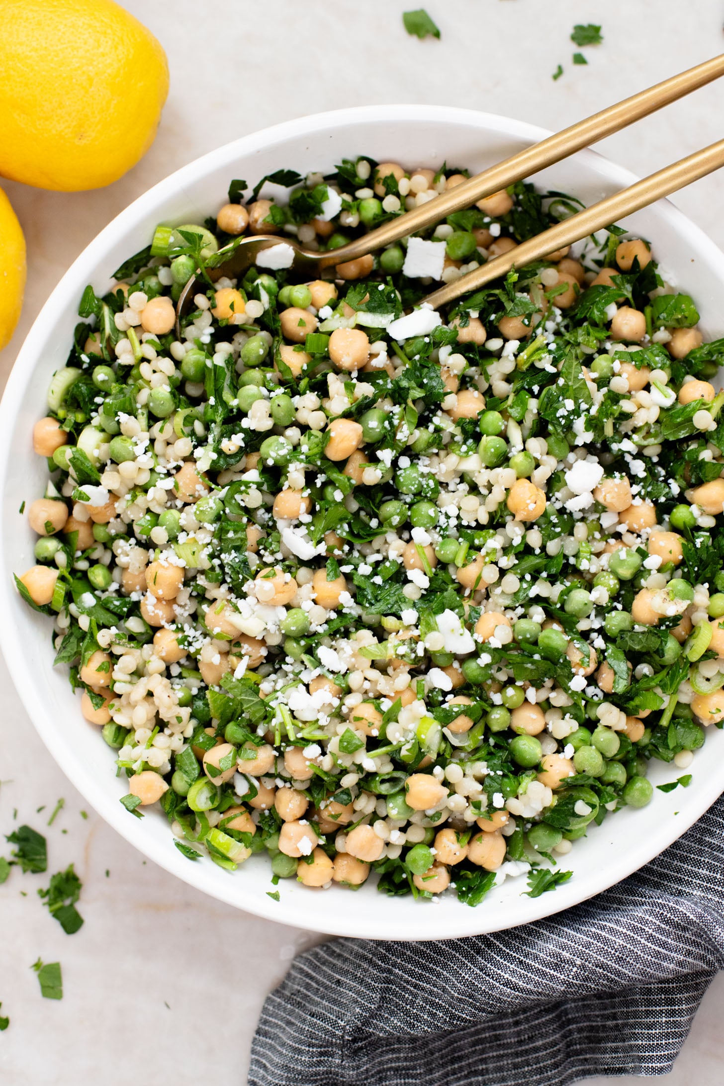 This Spring Pea Couscous Salad is filled with fresh herbs, English peas, chickpeas, pearl couscous and a delicious lemon dressing | ThisSavoryVegan.com