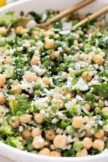 This Spring Pea Couscous Salad is filled with fresh herbs, English peas, chickpeas, pearl couscous and a delicious lemon dressing | ThisSavoryVegan.com