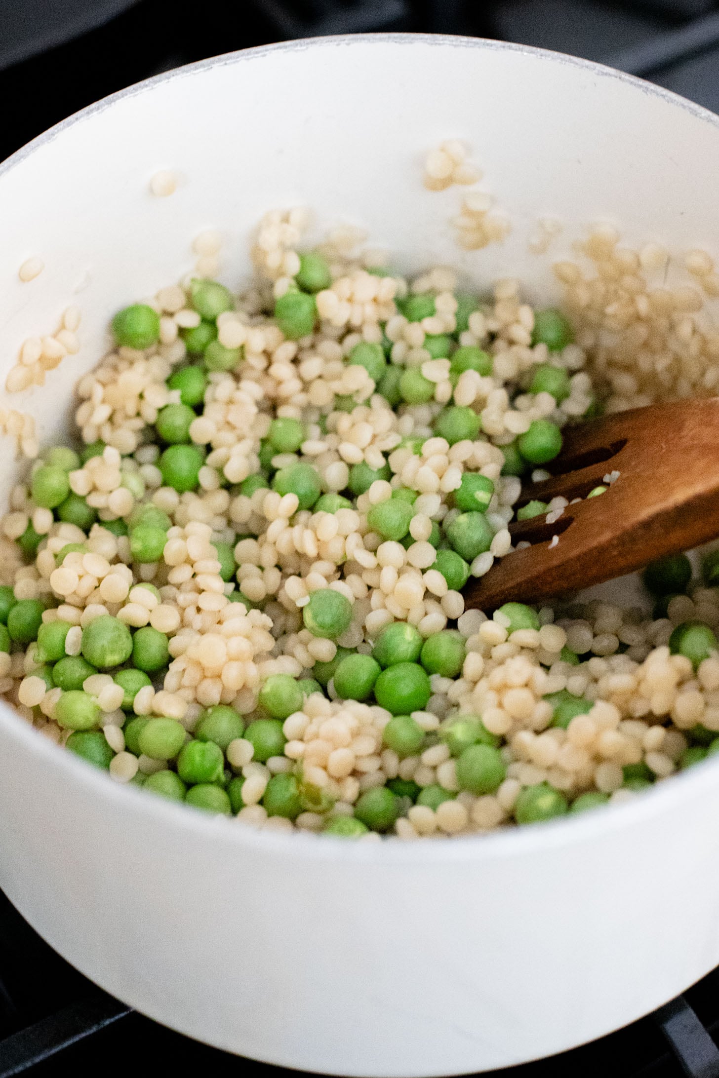 This Spring Pea Couscous Salad is filled with fresh herbs, English peas, chickpeas, pearl couscous and a delicious lemon dressing | ThisSavoryVegan.com