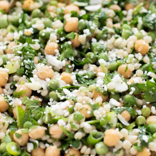 This Spring Pea Couscous Salad is filled with fresh herbs, English peas, chickpeas, pearl couscous and a delicious lemon dressing | ThisSavoryVegan.com