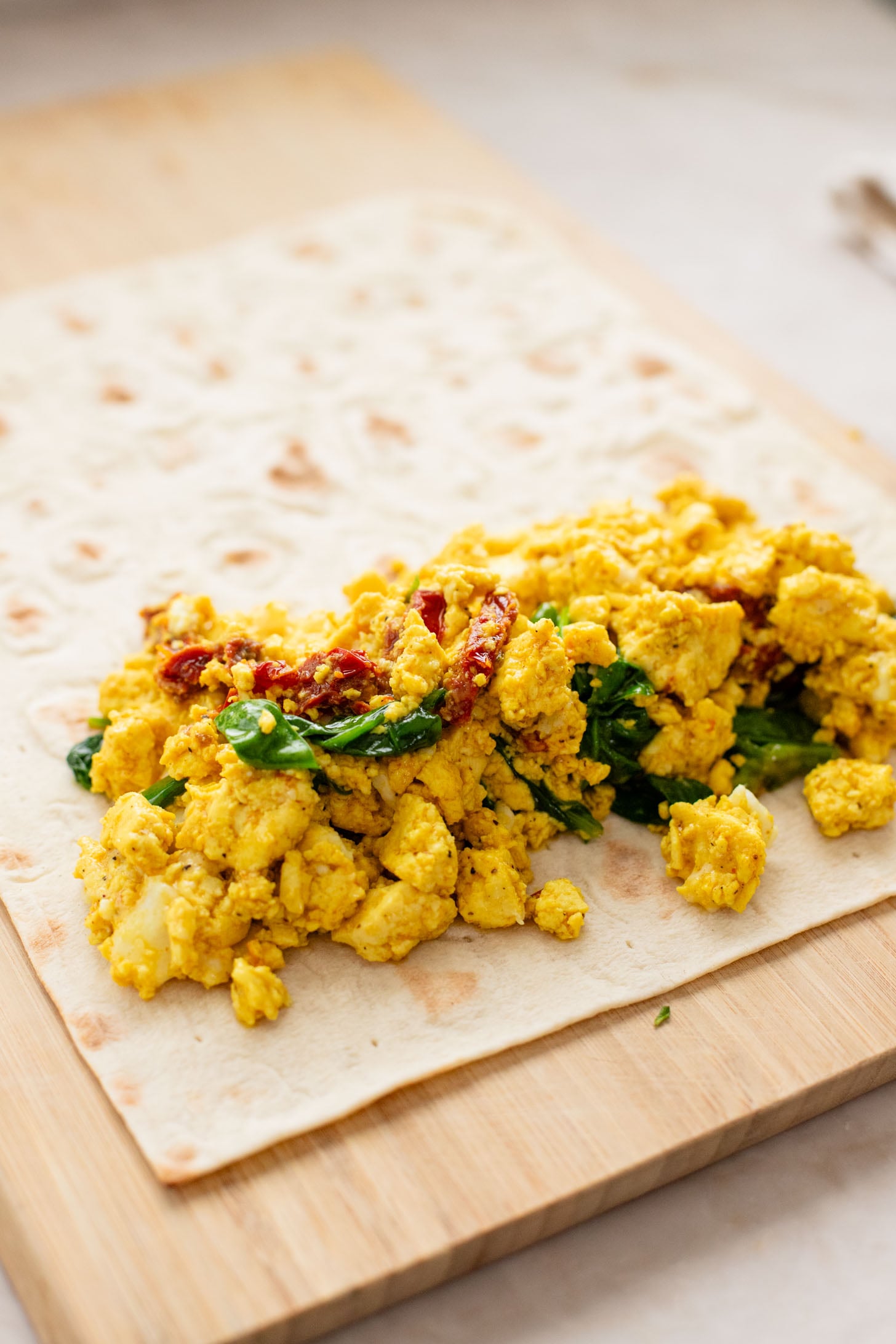 These Tofu Scramble Breakfast Wraps are a play on the Starbucks feta egg white wrap - but made dairy-free & with tofu | ThisSavoryVegan.com