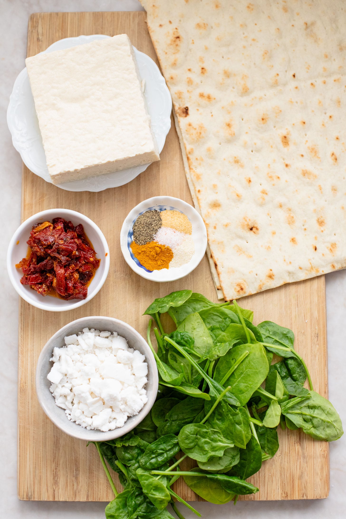 These Tofu Scramble Breakfast Wraps are a play on the Starbucks feta egg white wrap - but made dairy-free & with tofu | ThisSavoryVegan.com