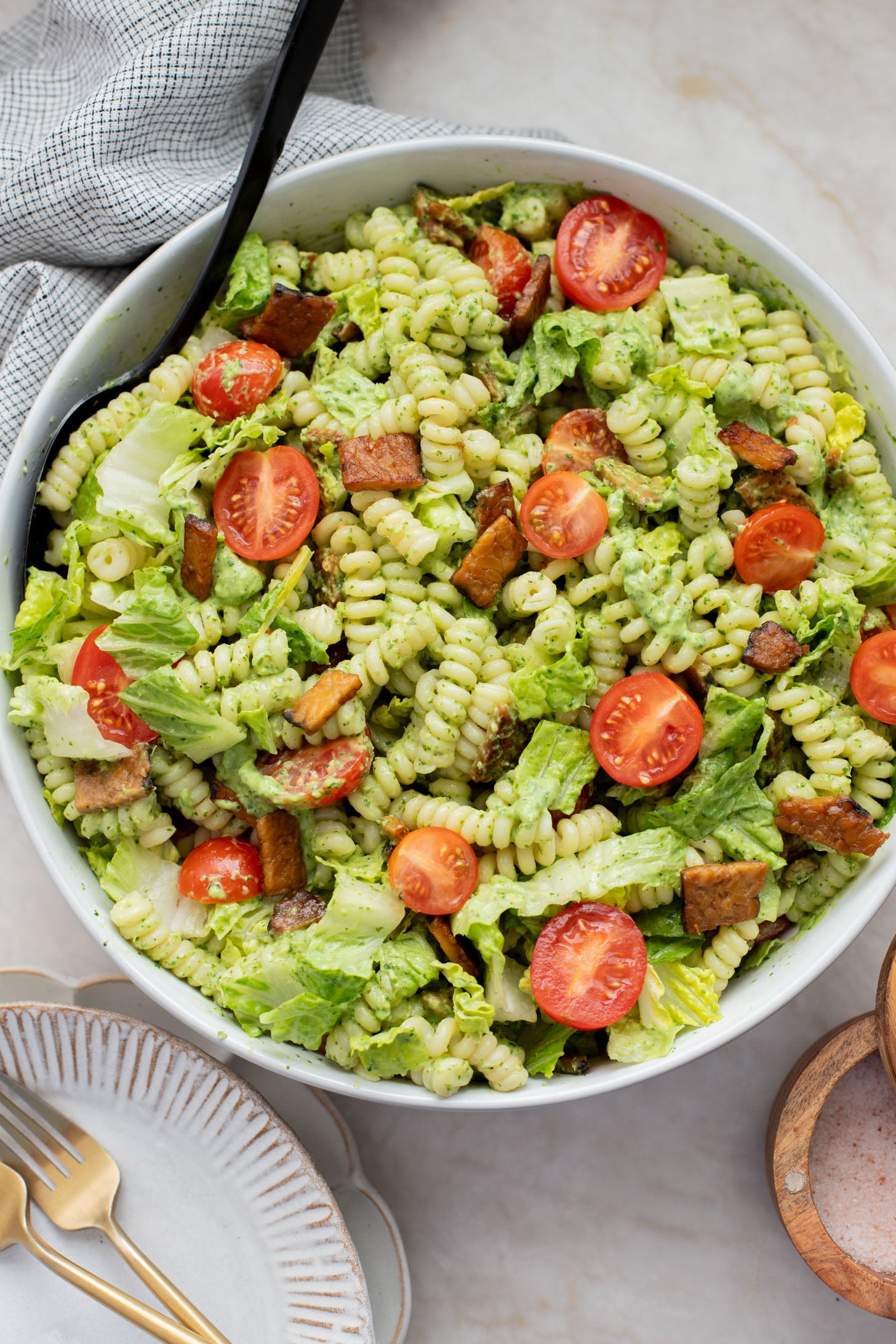 This TTLA Pasta Salad is the ultimate vegan take on a BLT pasta salad. It has a creamy avocado dressing, crispy tempeh and fresh veggies | ThisSavoryVegan.com