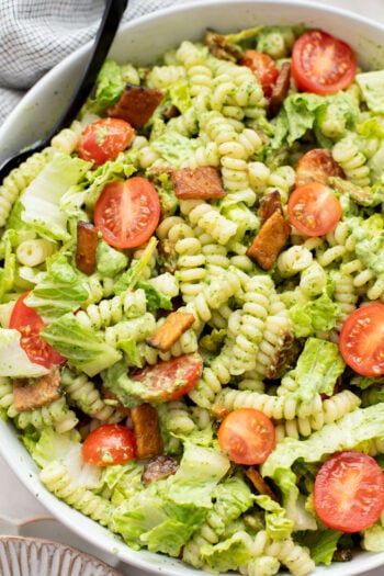 This TTLA Pasta Salad is the ultimate vegan take on a BLT pasta salad. It has a creamy avocado dressing, crispy tempeh and fresh veggies | ThisSavoryVegan.com