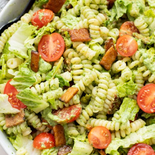 This TTLA Pasta Salad is the ultimate vegan take on a BLT pasta salad. It has a creamy avocado dressing, crispy tempeh and fresh veggies | ThisSavoryVegan.com