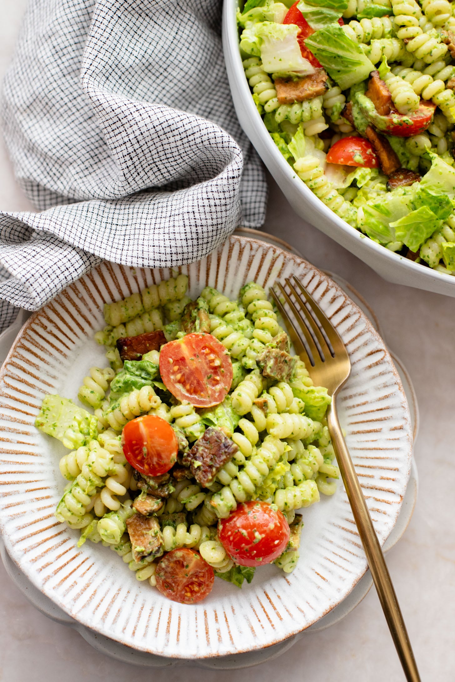 This TTLA Pasta Salad is the ultimate vegan take on a BLT pasta salad. It has a creamy avocado dressing, crispy tempeh and fresh veggies | ThisSavoryVegan.com