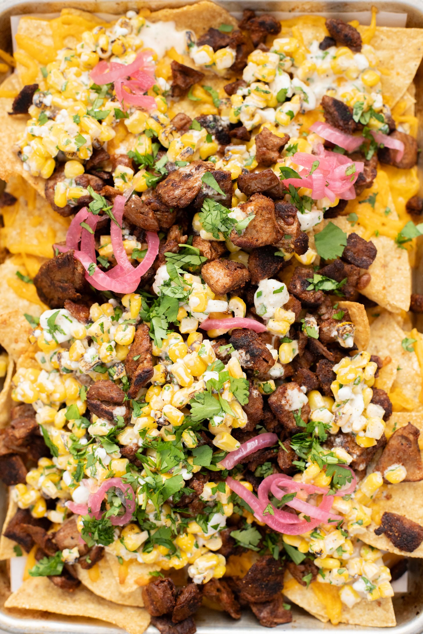 These Vegan Steak Nachos with Elote Salsa are the best game day snack! Ready in less than 30 minutes and perfect for sharing | ThisSavoryVegan.com