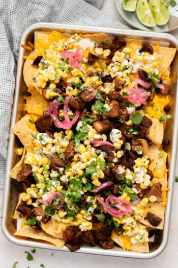These Vegan Steak Nachos with Elote Salsa are the best game day snack! Ready in less than 30 minutes and perfect for sharing | ThisSavoryVegan.com