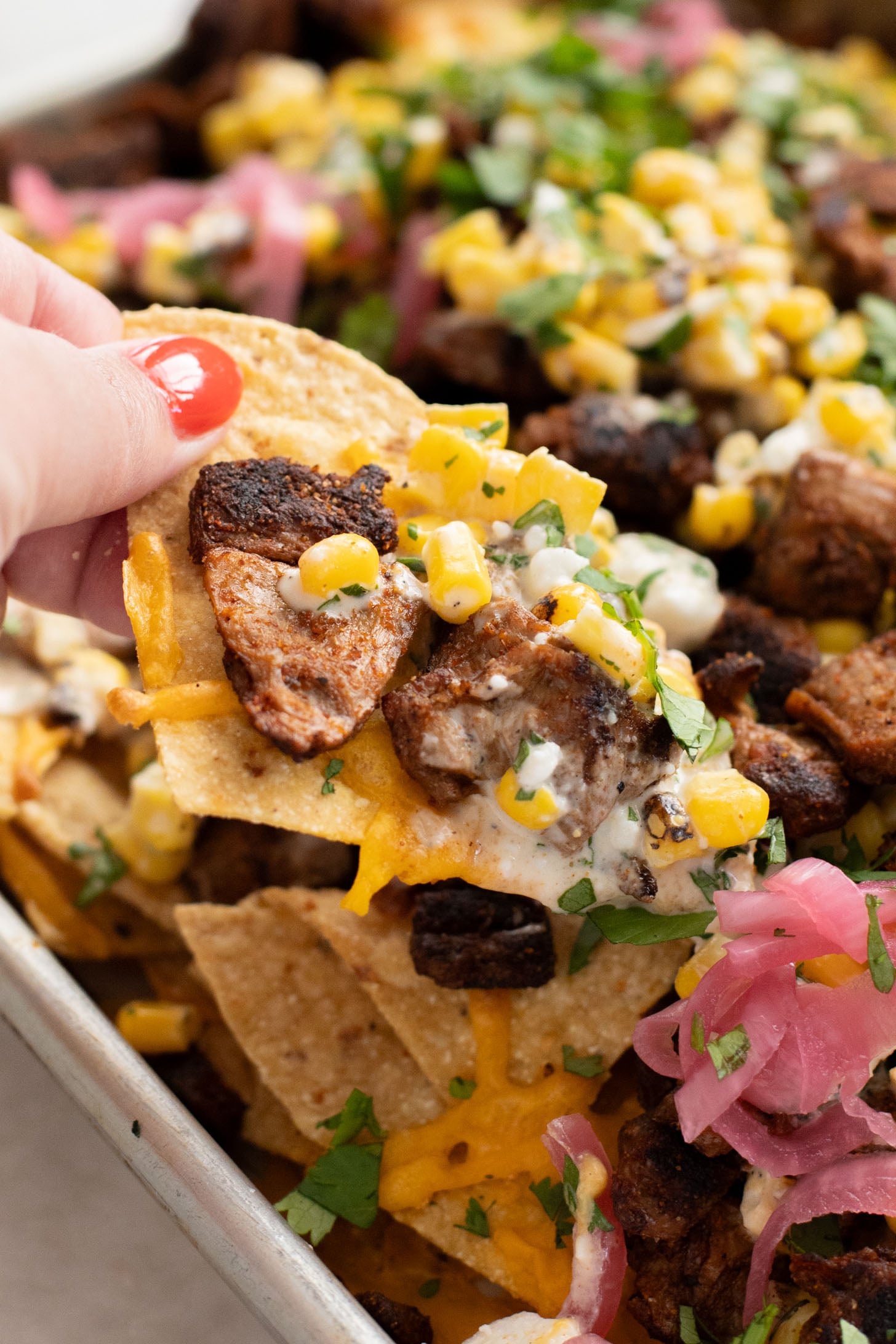 These Vegan Steak Nachos with Elote Salsa are the best game day snack! Ready in less than 30 minutes and perfect for sharing | ThisSavoryVegan.com