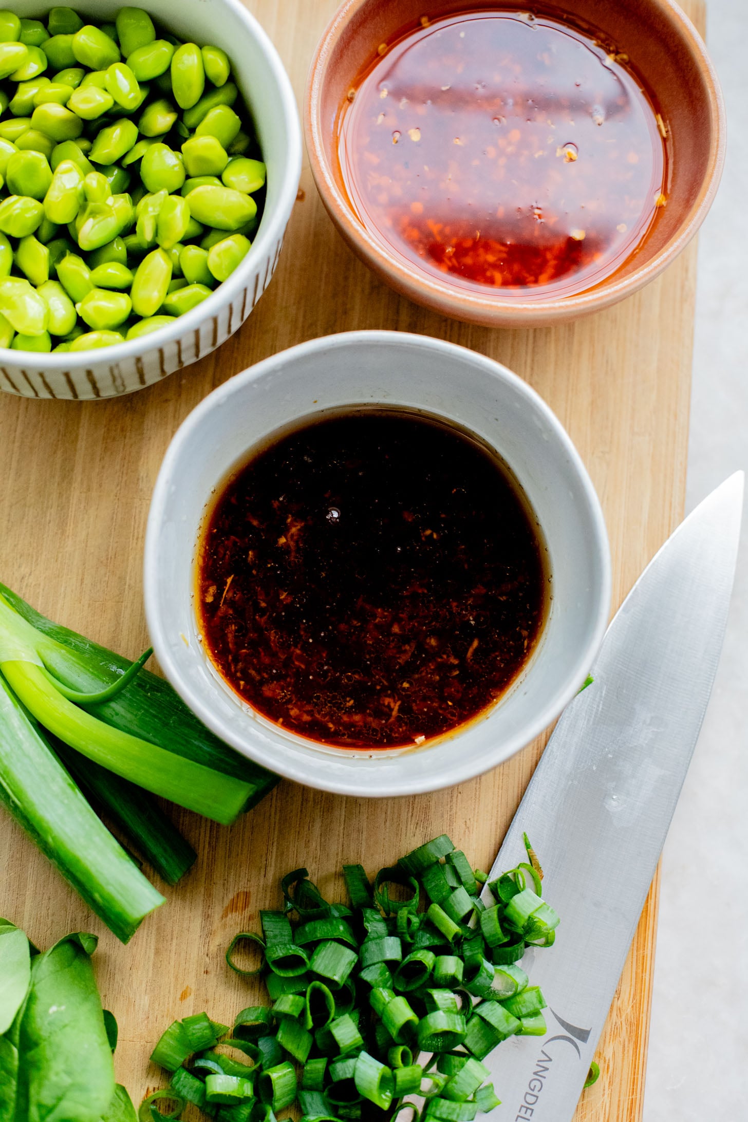 This Cold Edamame Noodle Salad is the perfect dinner when you want something fresh & comforting. Topped with chili crisp for a little heat & packed with plant protein | ThisSavoryVegan.com