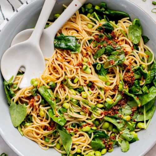 This Cold Edamame Noodle Salad is the perfect dinner when you want something fresh & comforting. Topped with chili crisp for a little heat & packed with plant protein | ThisSavoryVegan.com