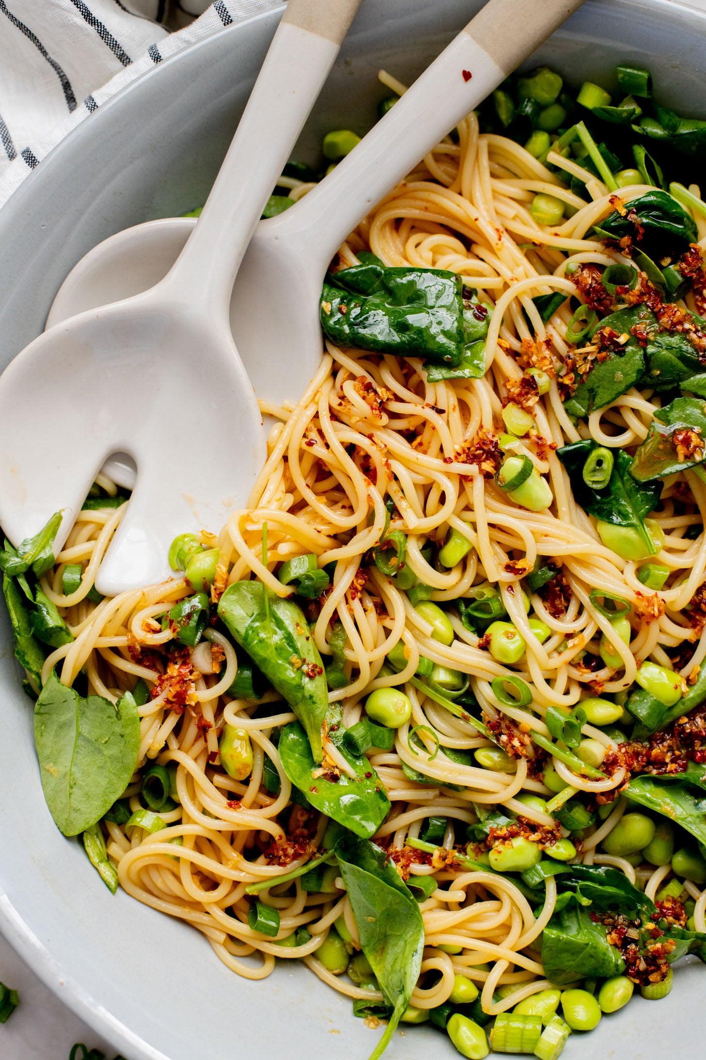 This Cold Edamame Noodle Salad is the perfect dinner when you want something fresh & comforting. Topped with chili crisp for a little heat & packed with plant protein | ThisSavoryVegan.com
