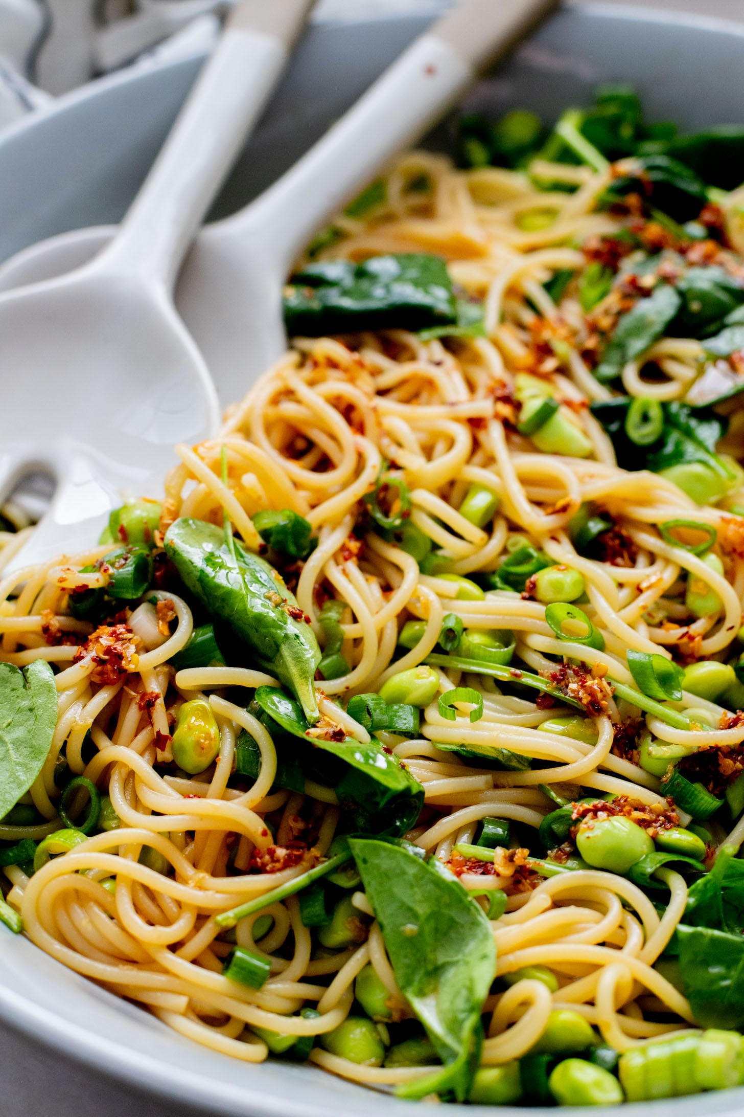 This Cold Edamame Noodle Salad is the perfect dinner when you want something fresh & comforting. Topped with chili crisp for a little heat & packed with plant protein | ThisSavoryVegan.com