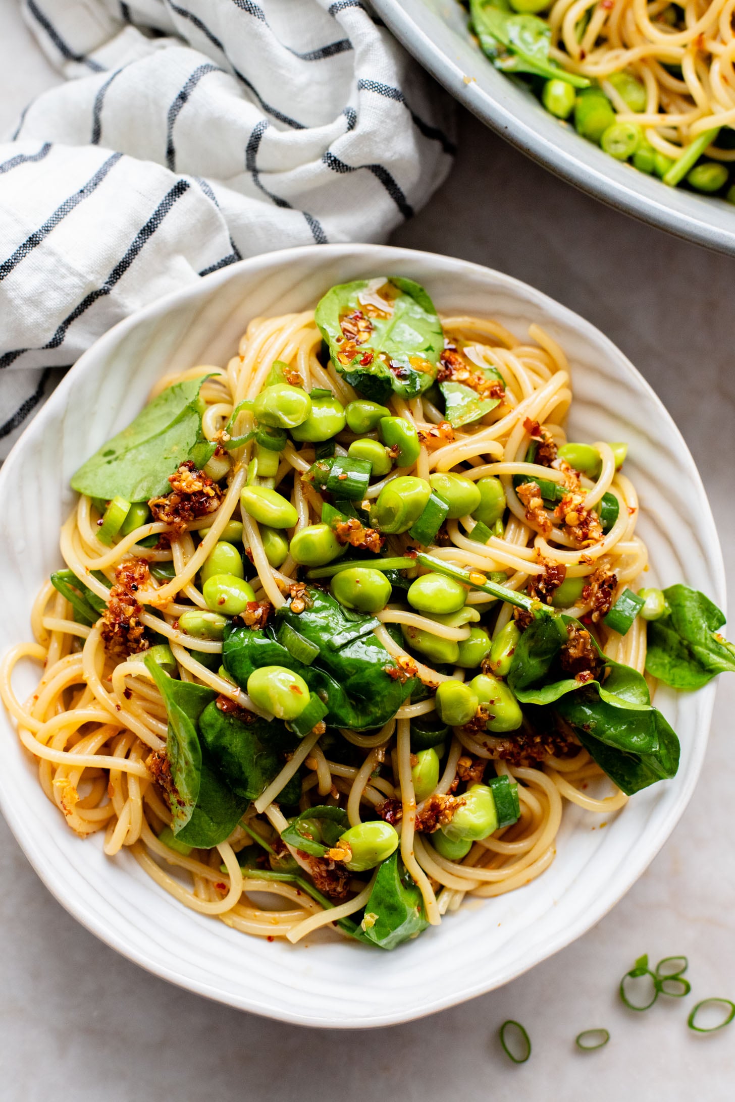 This Cold Edamame Noodle Salad is the perfect dinner when you want something fresh & comforting. Topped with chili crisp for a little heat & packed with plant protein | ThisSavoryVegan.com