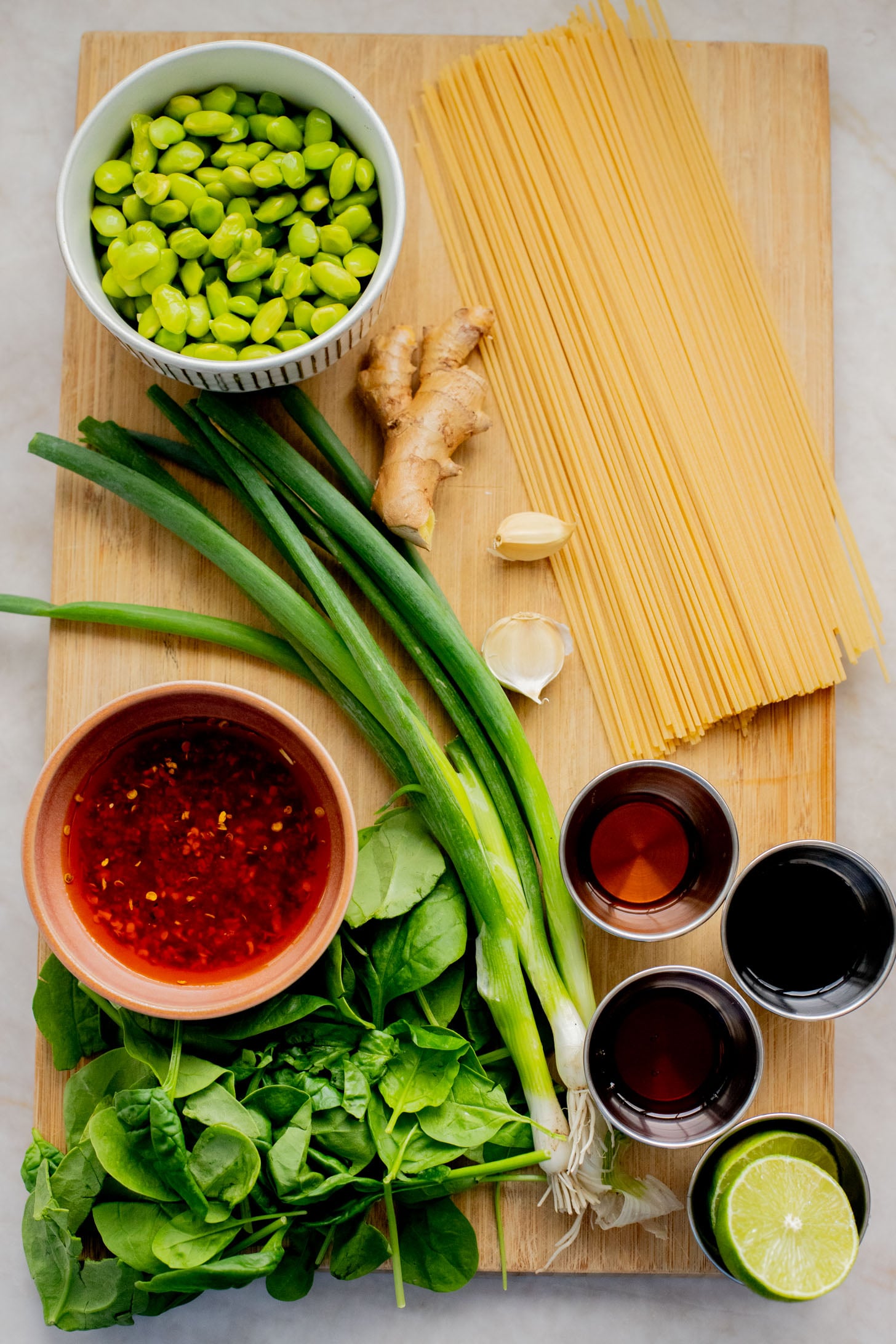 This Cold Edamame Noodle Salad is the perfect dinner when you want something fresh & comforting. Topped with chili crisp for a little heat & packed with plant protein | ThisSavoryVegan.com