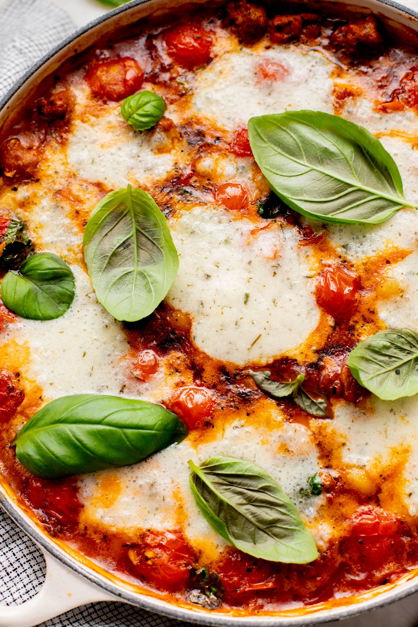 This Soupy Tomato Basil Gnocchi Bake is the perfect soup, that isn't a soup. Gnocchi is baked in a tomato broth and topped with vegan cheese | ThisSavoryVegan.com