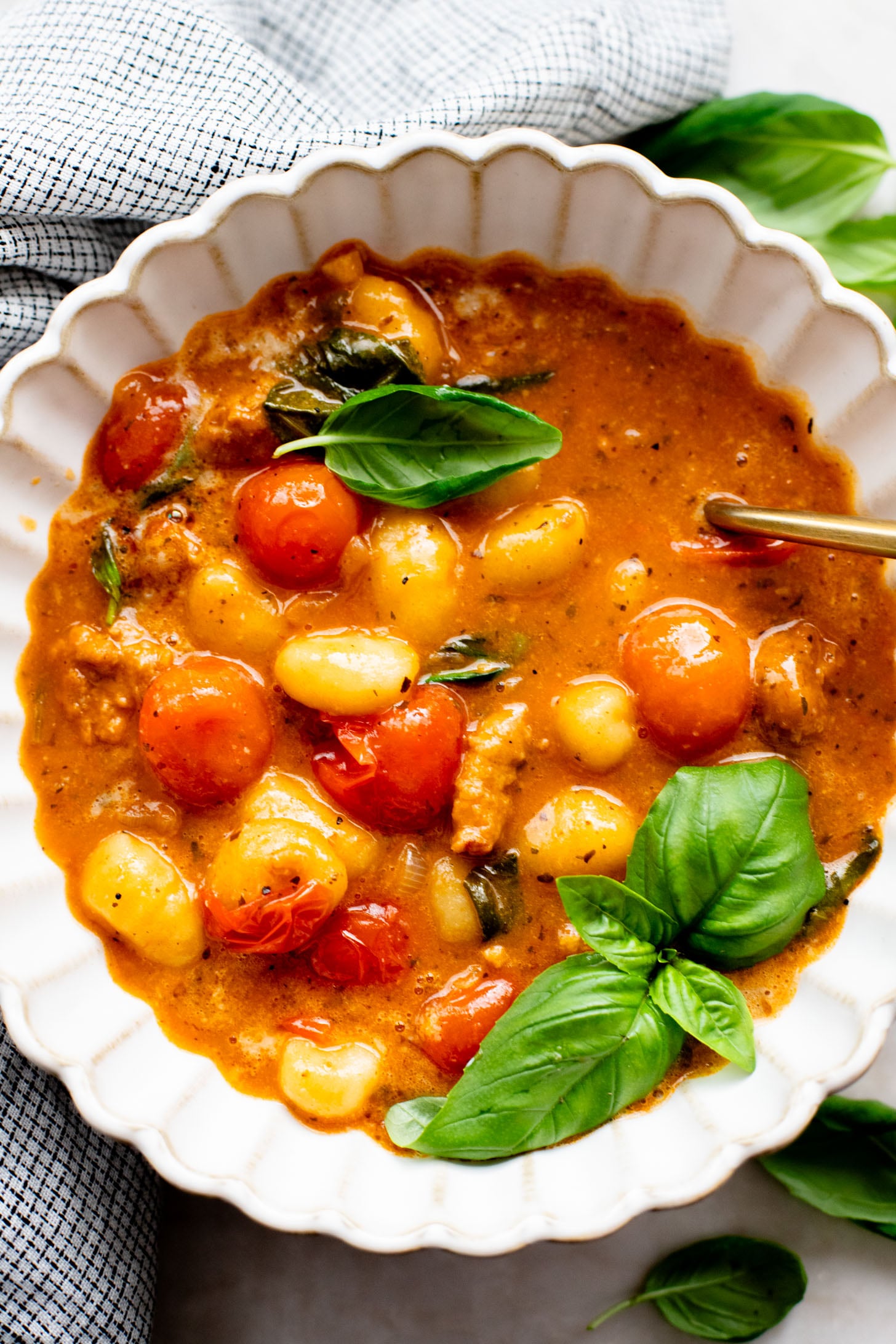 This Soupy Tomato Basil Gnocchi Bake is the perfect soup, that isn't a soup. Gnocchi is baked in a tomato broth and topped with vegan cheese | ThisSavoryVegan.com