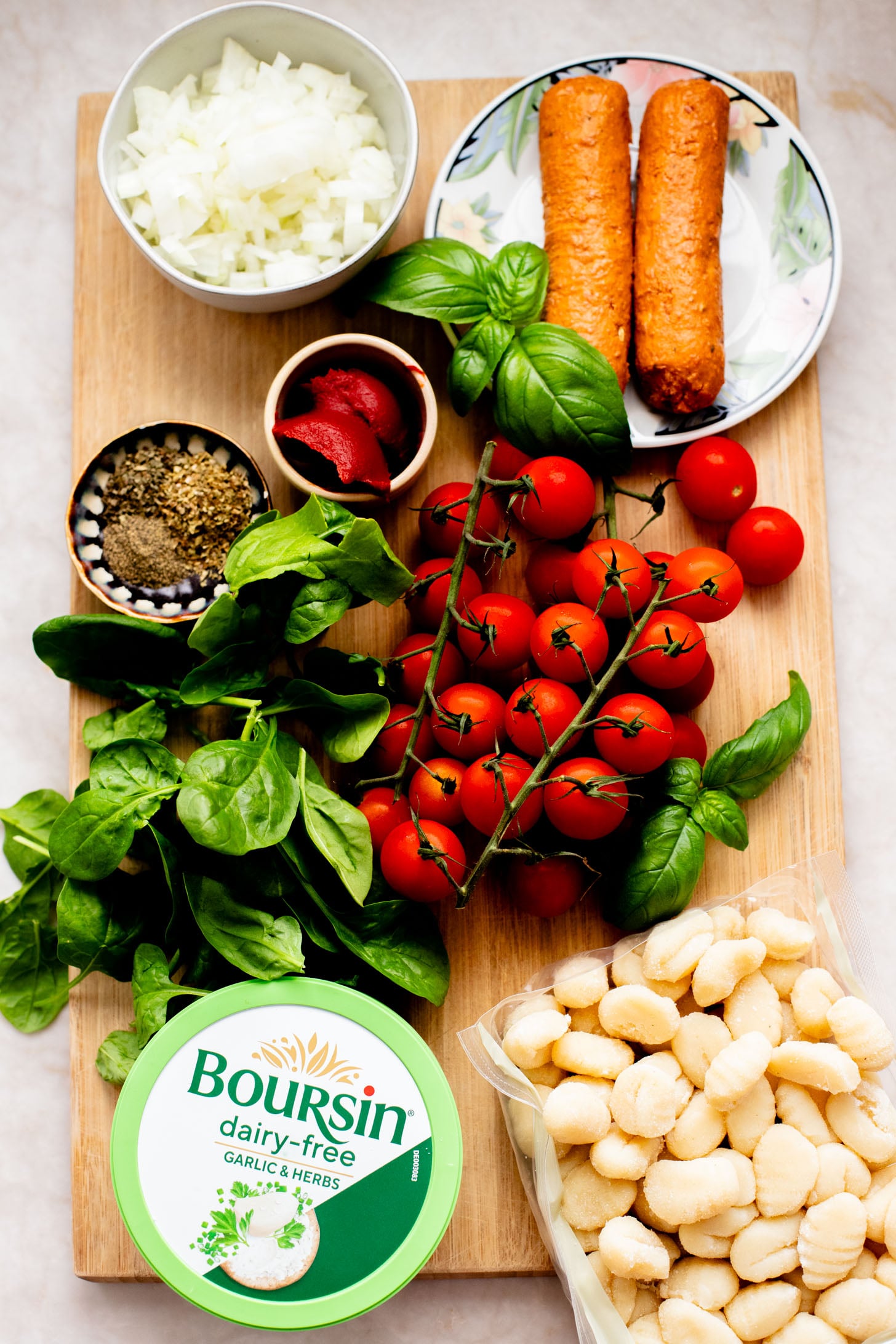 This Soupy Tomato Basil Gnocchi Bake is the perfect soup, that isn't a soup. Gnocchi is baked in a tomato broth and topped with vegan cheese | ThisSavoryVegan.com