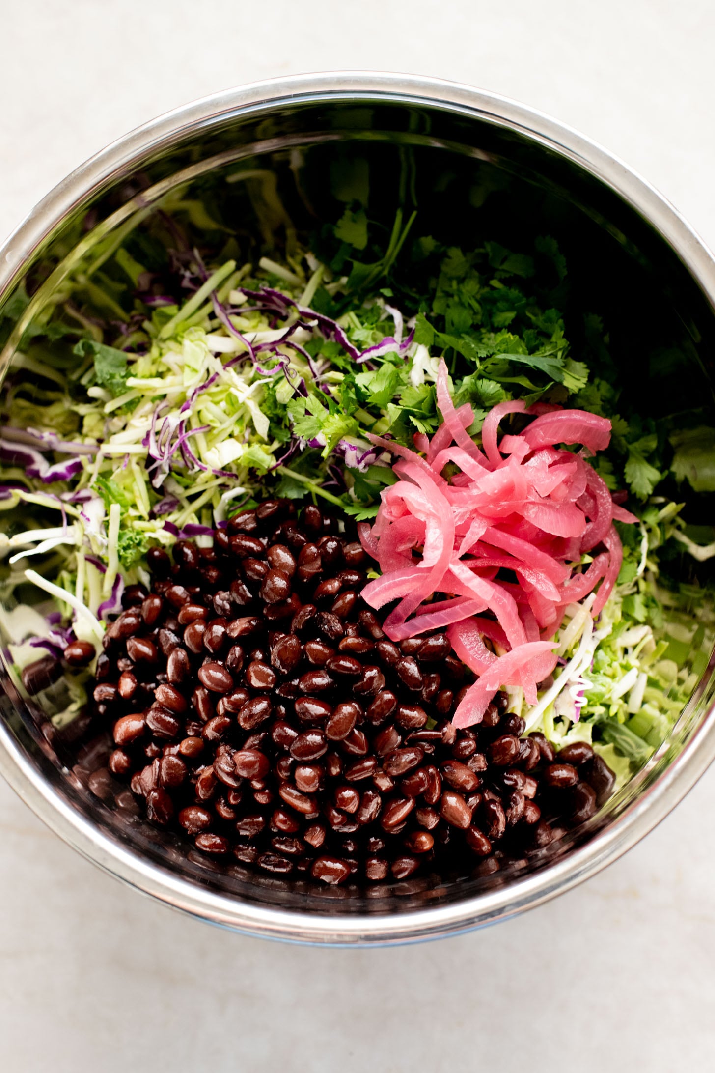 This Trader Joe's Black Bean Crunch Salad is a flavor bomb. Crisp kale slaw, black beans, crunchy jalapeños, pickled onions & a delicious cilantro lime dressing | ThisSavoryVegan.com