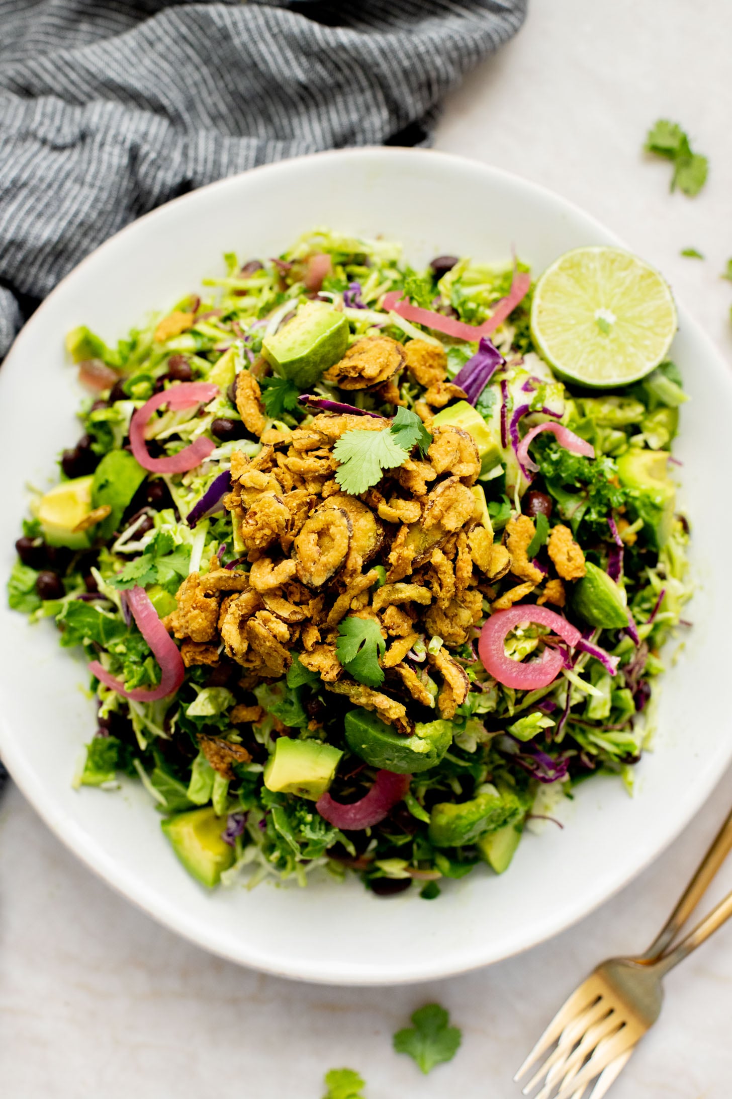 This Trader Joe's Black Bean Crunch Salad is a flavor bomb. Crisp kale slaw, black beans, crunchy jalapeños, pickled onions & a delicious cilantro lime dressing | ThisSavoryVegan.com