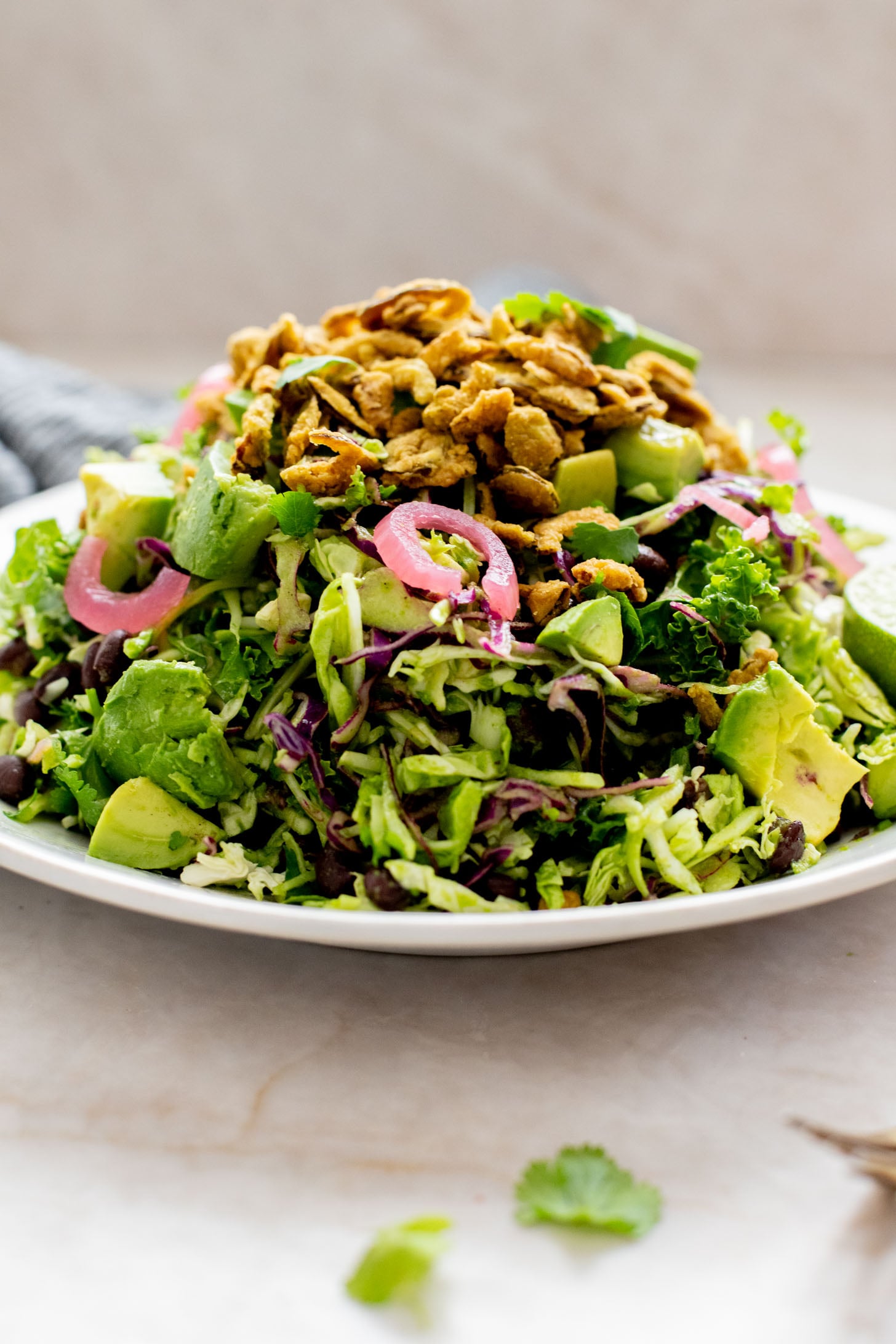 This Trader Joe's Black Bean Crunch Salad is a flavor bomb. Crisp kale slaw, black beans, crunchy jalapeños, pickled onions & a delicious cilantro lime dressing | ThisSavoryVegan.com