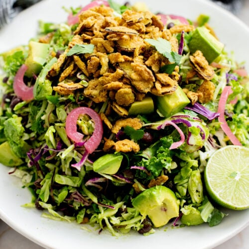 This Trader Joe's Black Bean Crunch Salad is a flavor bomb. Crisp kale slaw, black beans, crunchy jalapeños, pickled onions & a delicious cilantro lime dressing | ThisSavoryVegan.com